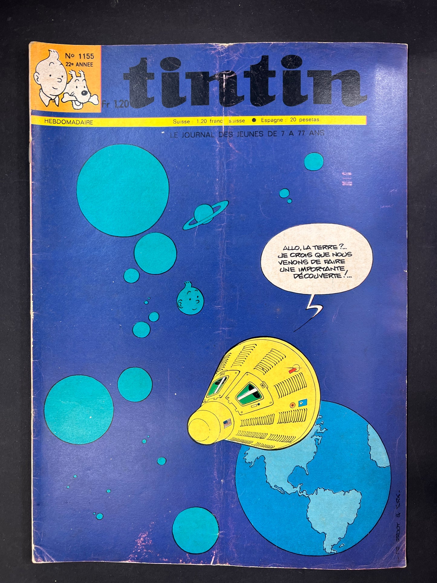 Vintage Tintin magazine cover with blue background and yellow vehicle illustration