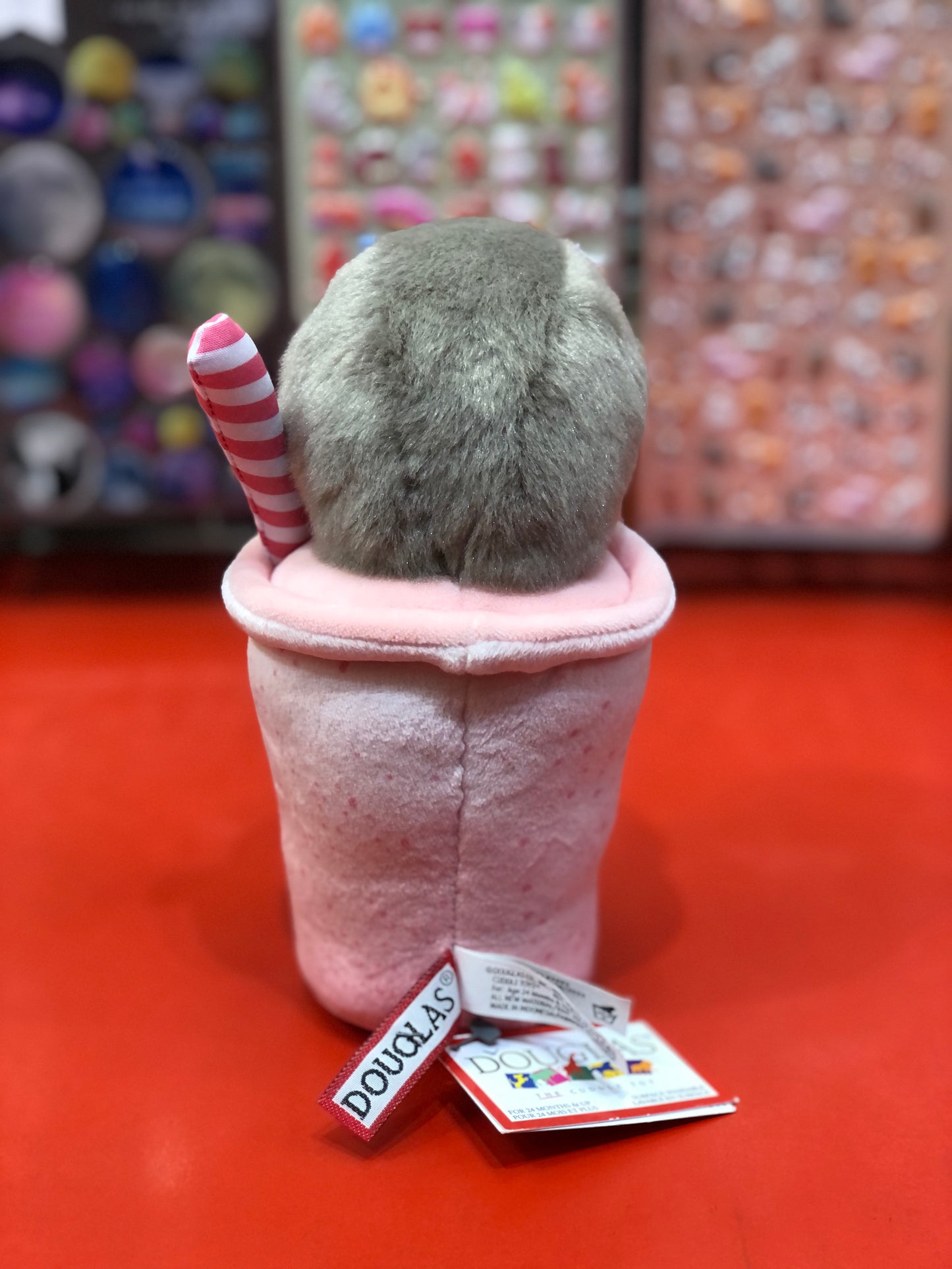 Douglas Slothberry Smoothie plush toy: gray fuzzy head peeking out of pink cup with striped straw, tags attached