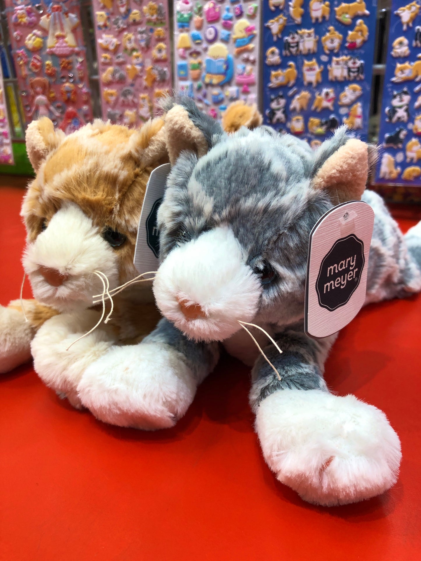 Mary Meyer FabFuzz Waffles Kittens plush toys in orange and gray, soft and textured, displayed with brand tag on red surface
