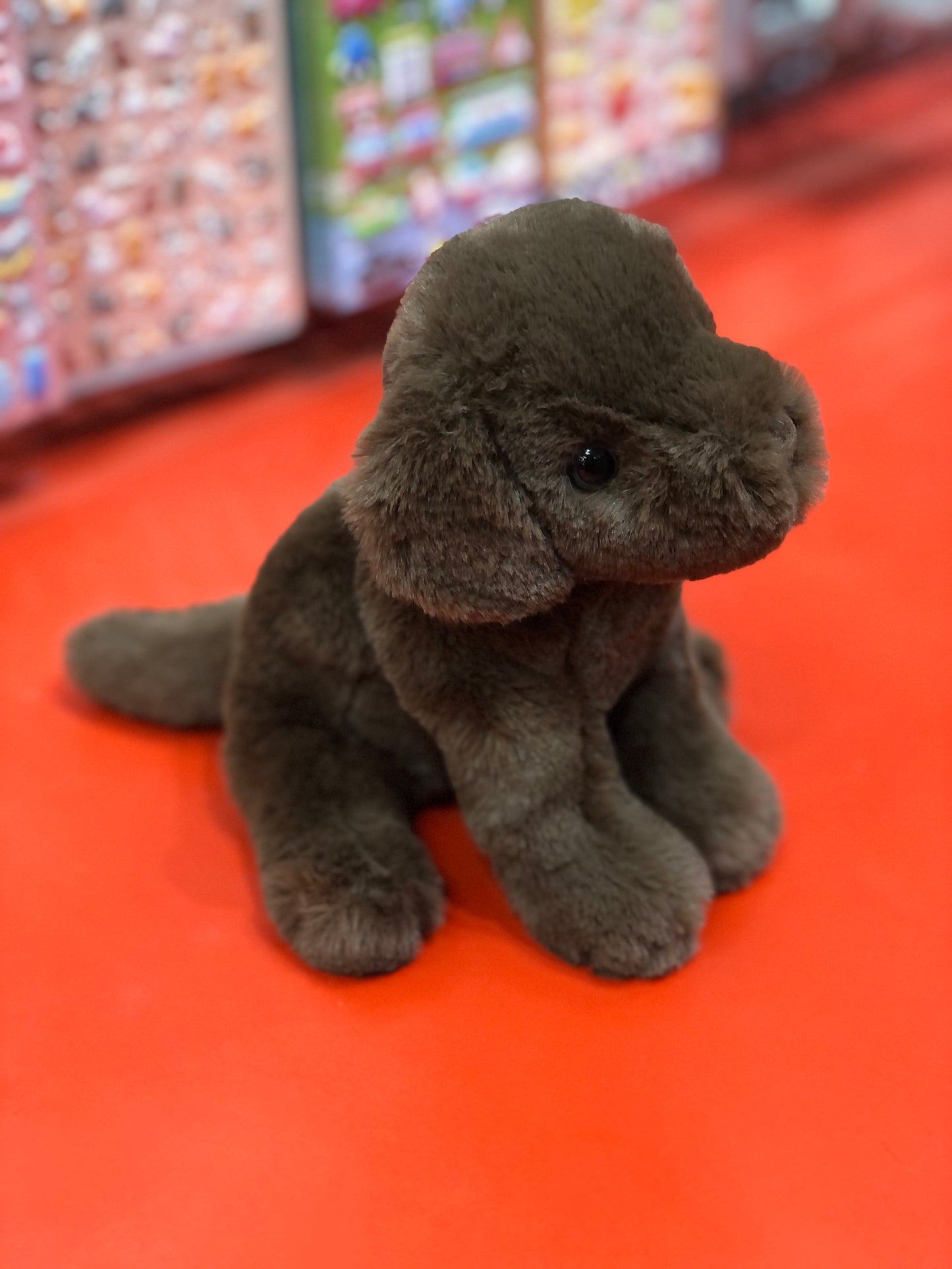 Adorable chocolate Labrador puppy plush toy on red background, soft and cuddly 6-inch stuffed animal for dog lovers