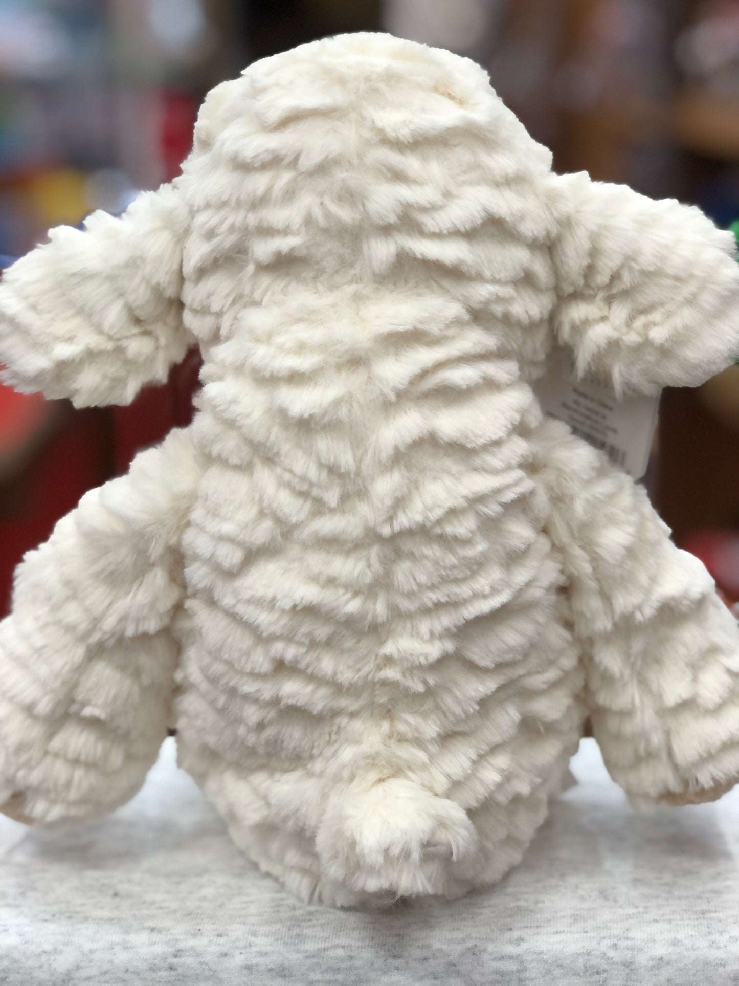 Soft, fluffy white Marshmallow Lamb plush toy, 13 inches tall, viewed from behind showing textured fur and floppy ears