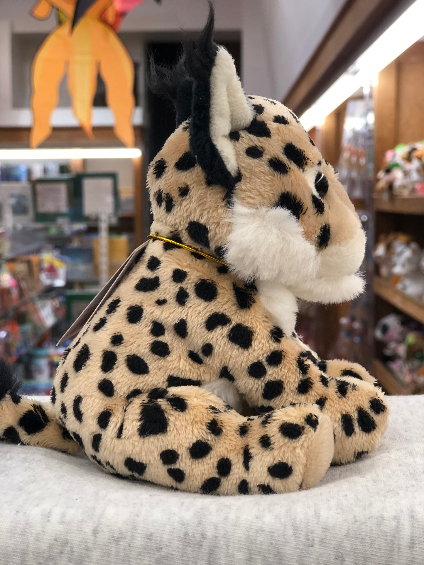 Soft, spotted Charlie Bears Cuddle Cub Lynx plush toy displayed in a store, perfect for babies and small hands