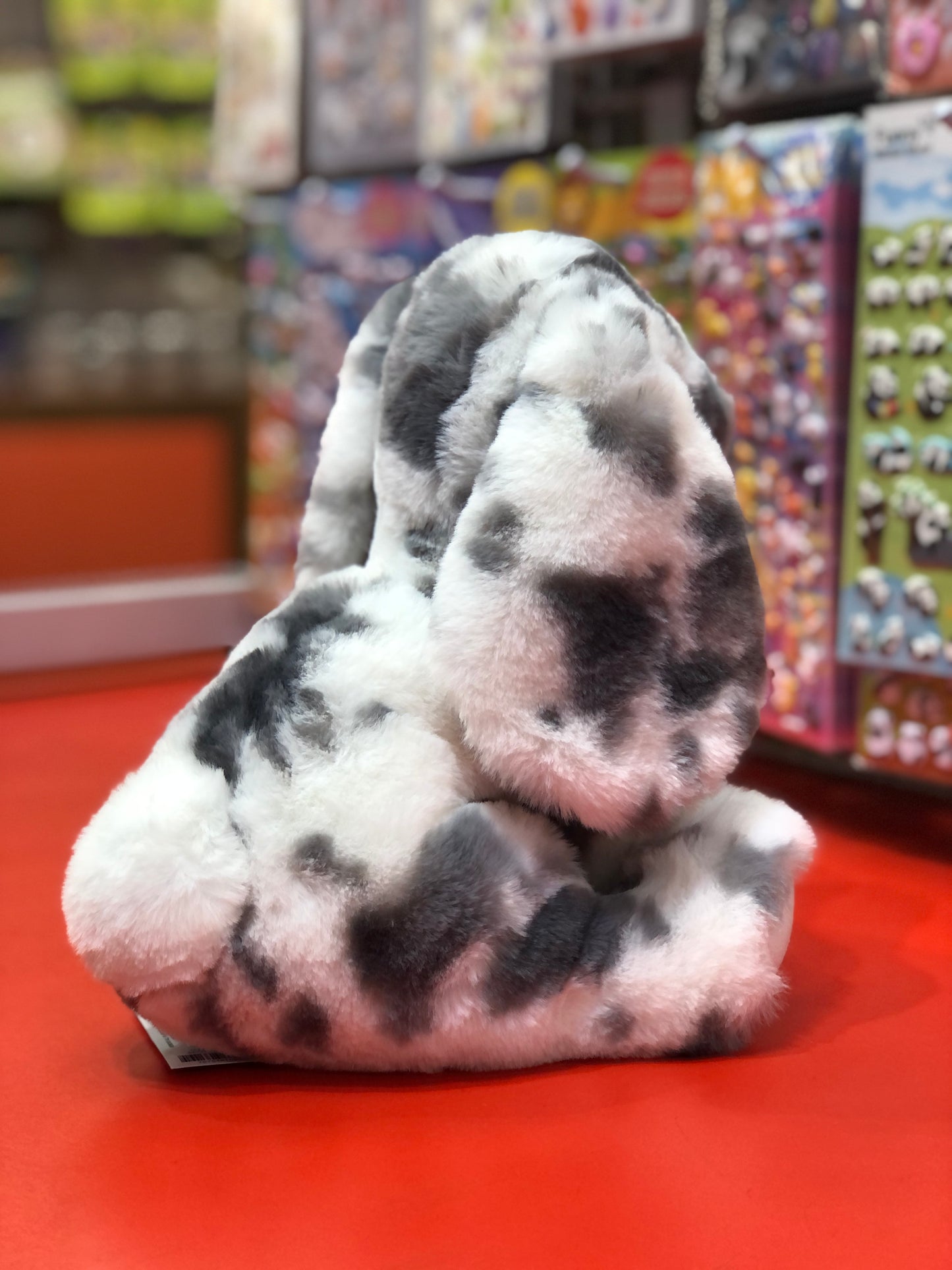 Soft plush Douglas Bouncie spotted bunny toy with lop ears and oversized paws on display in toy store