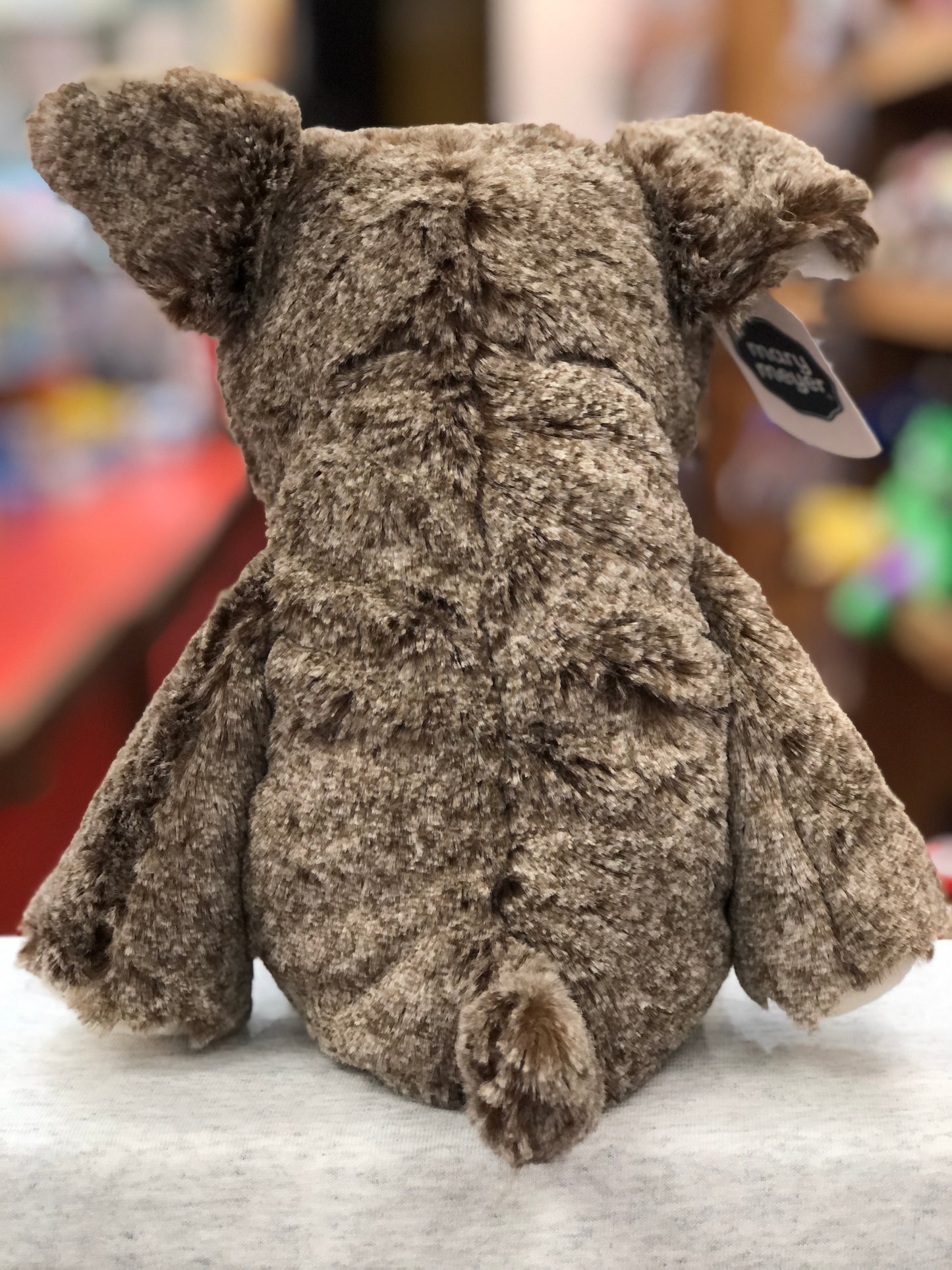 Soft, cuddly Mary Meyer Marshmallow Bradley Bulldog plush toy with floppy ears and legs, viewed from behind