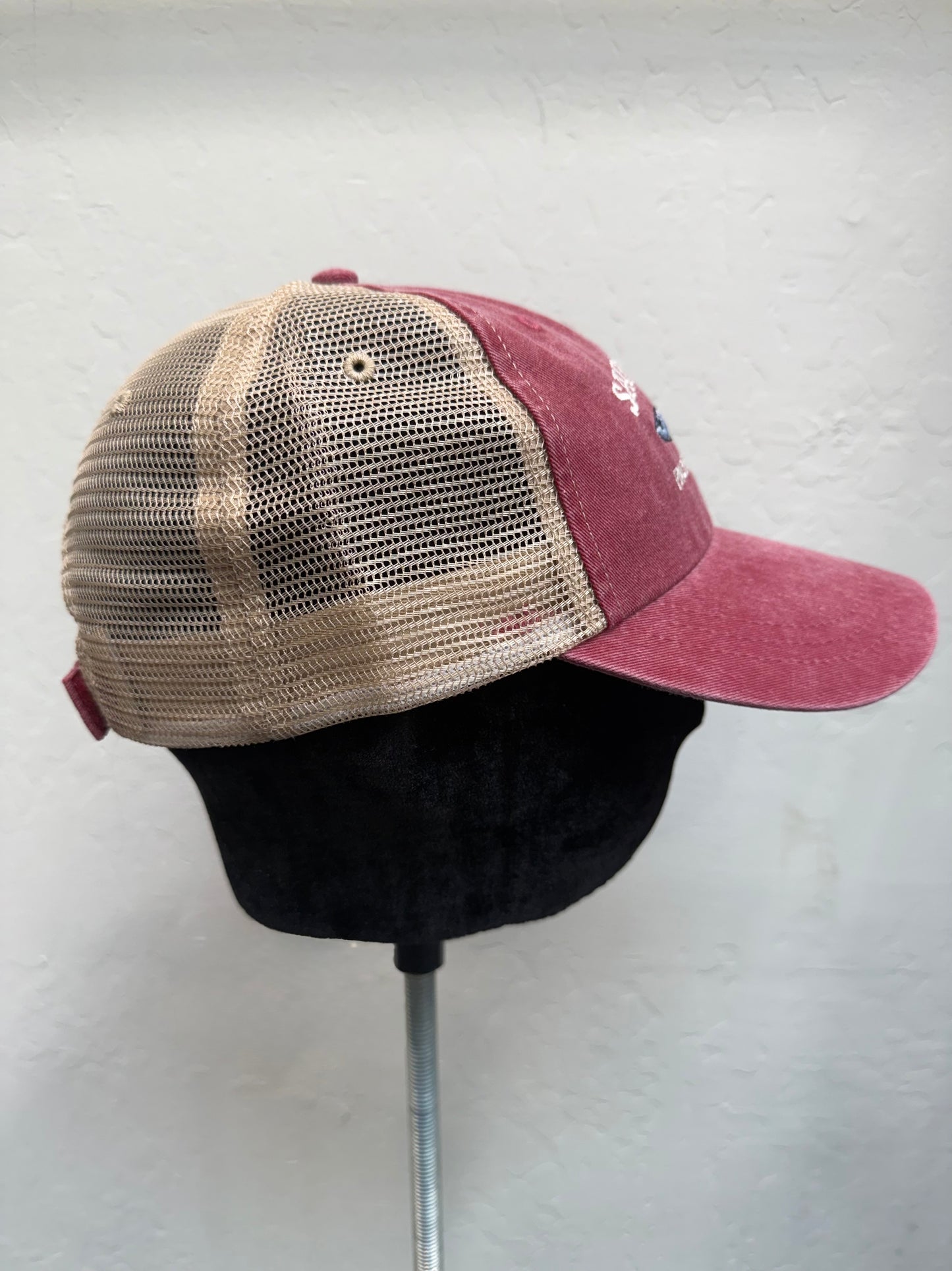 Sausalito Pacific Herring washed trucker cap with burgundy front and tan mesh back, displayed on stand