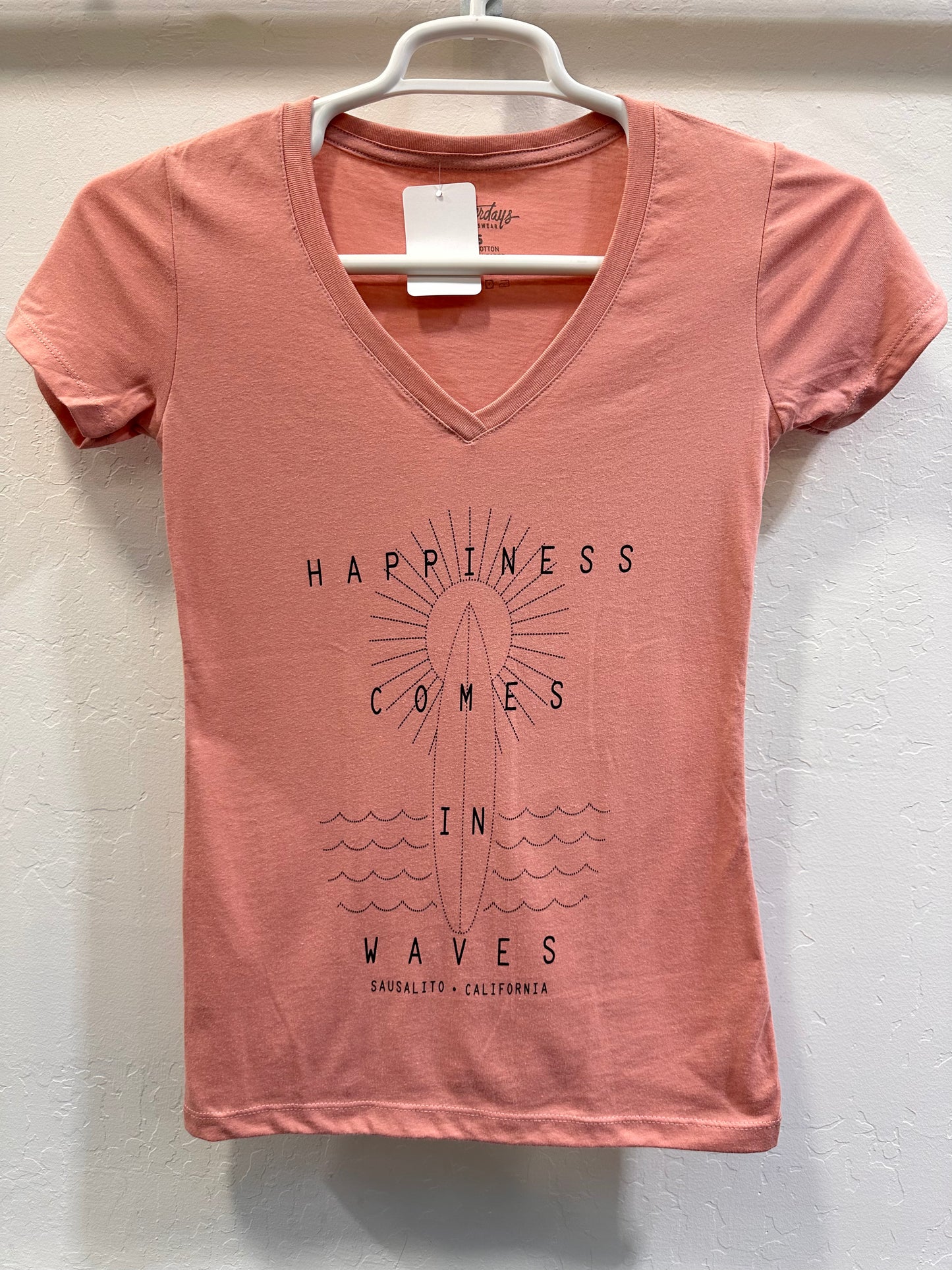 Sausalito "Happiness Comes in Waves" women's v-neck t-shirt with sun and surfboard design, coral color