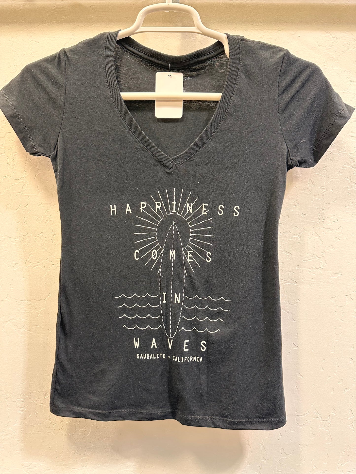 Women's v-neck t-shirt with "Happiness Comes in Waves" Sausalito surf design featuring sun, surfboard, and waves