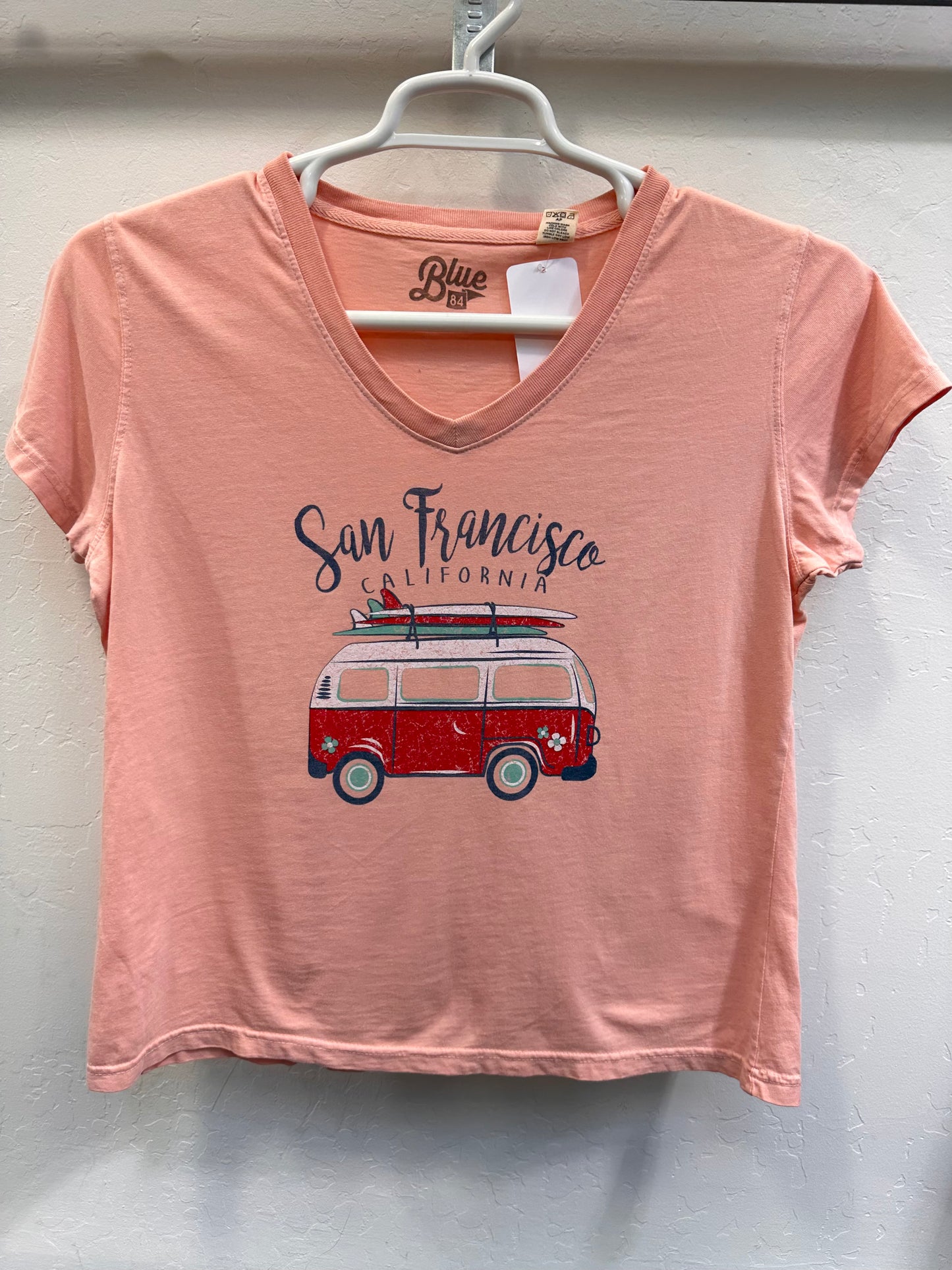 Pink women's v-neck t-shirt with San Francisco surf van graphic, featuring retro design and California beach vibes
