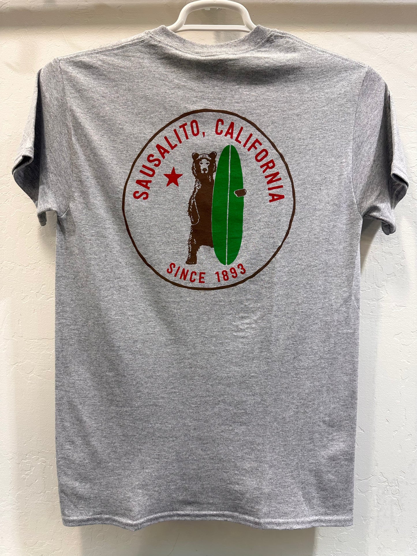 Gray t-shirt with Sausalito, California logo featuring surfing grizzly bear, green surfboard, and "Since 1893" text