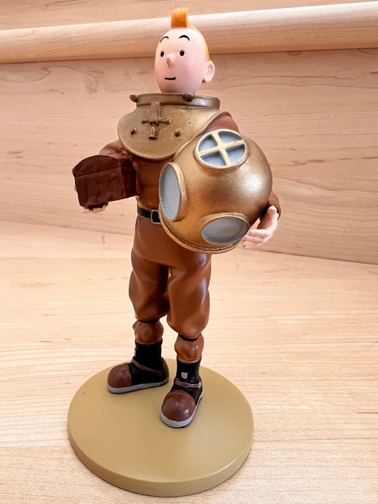 Tintin resin figure in vintage diving suit, exploring Red Rackham's ship. 12cm collectible on display stand.