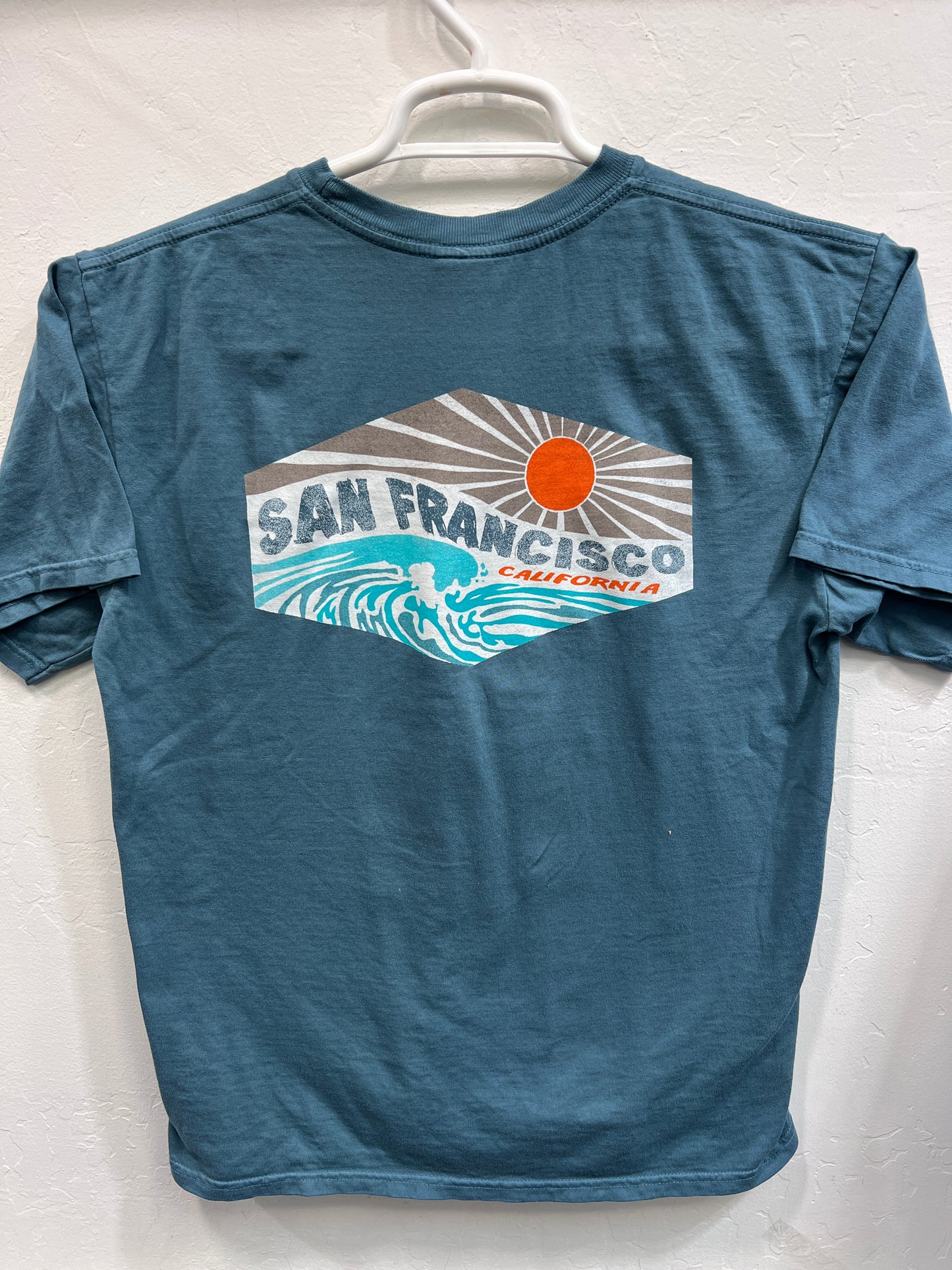 Navy Affirmation Wave t-shirt with San Francisco sunset and wave design, showcasing positive vibes and California style