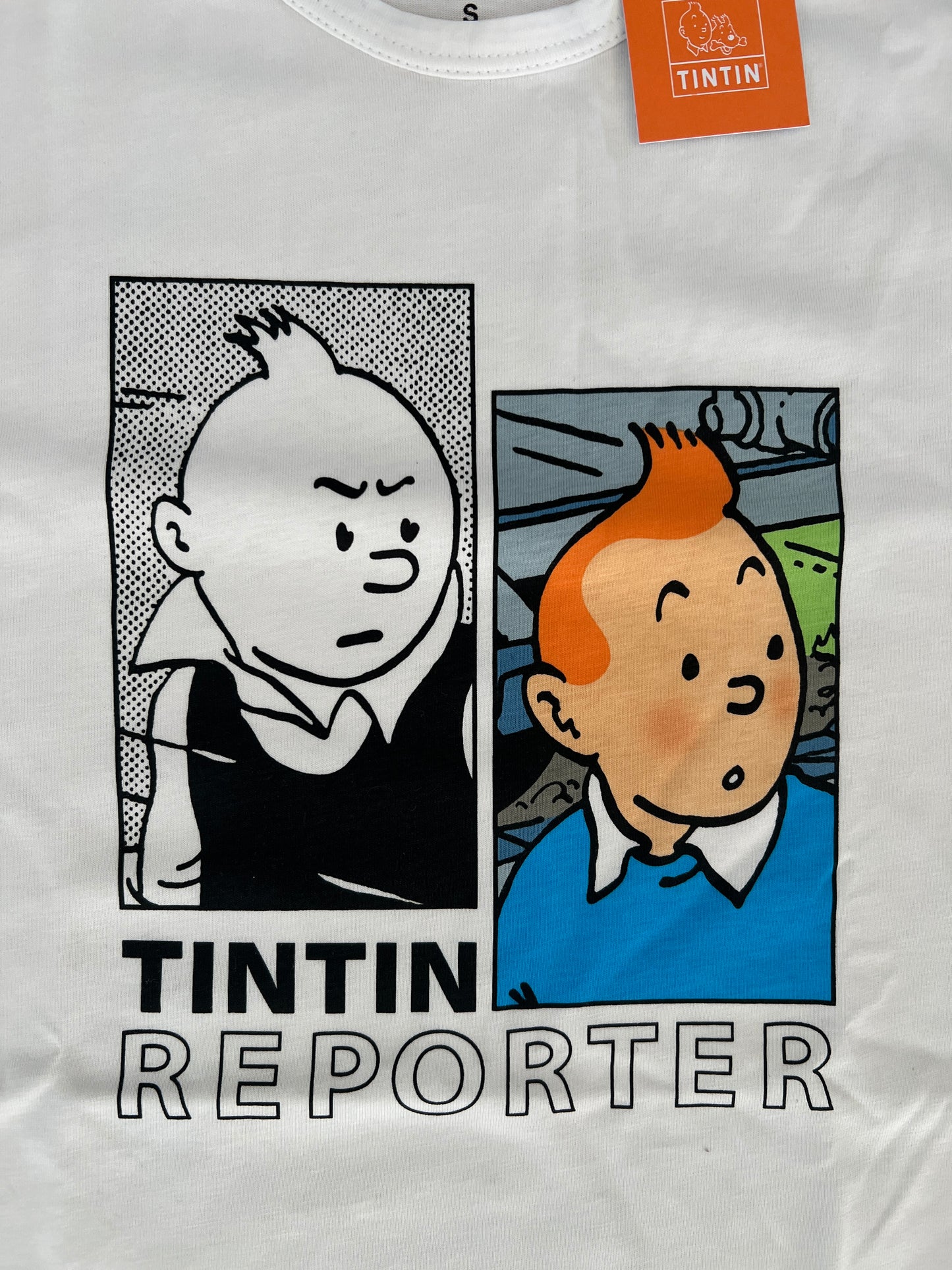 White Tintin Reporter t-shirt with dual comic panels showing displeased and astonished expressions, official Tintin tag visible