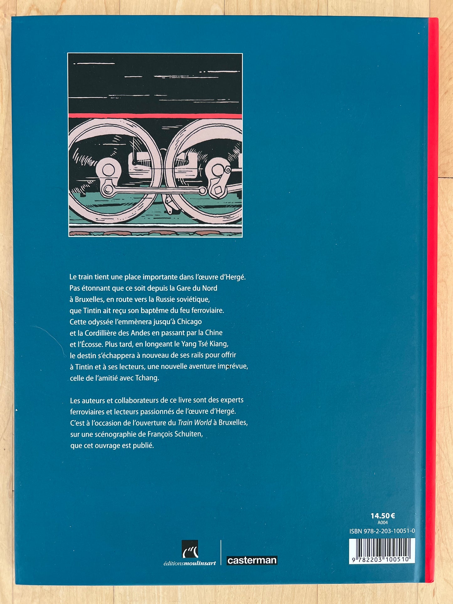 Book cover "Hergé, Tintin Et Les Trains" featuring train wheels illustration and French text about Tintin's railway adventures