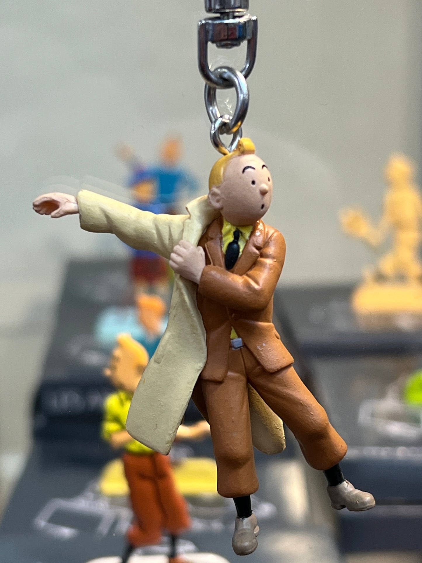 Tintin keychain figurine wearing iconic trench coat, 5.5cm tall, attached to heavy-duty key ring