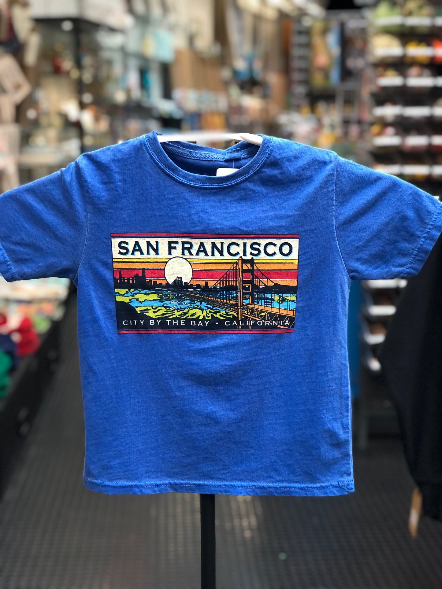 Royal blue kids t-shirt with a retro-style orange sunset and Golden Gate Bridge illustration