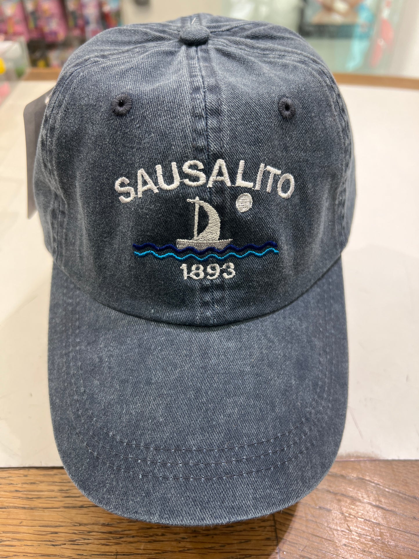 Sail with the wind at your back and a full moon in the sky with this 100% cotton cap. Soft to start with, the cotton will become more lush as it wears. Metal slip buckle allows adjustment of strap so the cap will fit most head sizes. Cap colors are denim, grey and red.