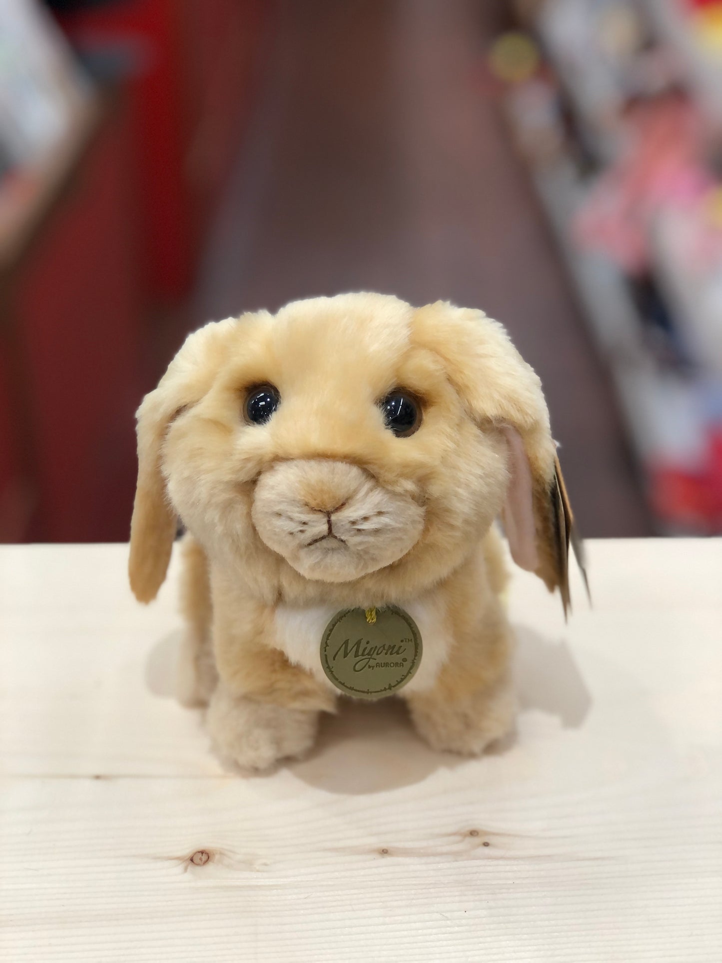 Adorable Aurora Miyoni lop-eared rabbit plush toy with soft beige fur and expressive eyes, displayed on white surface