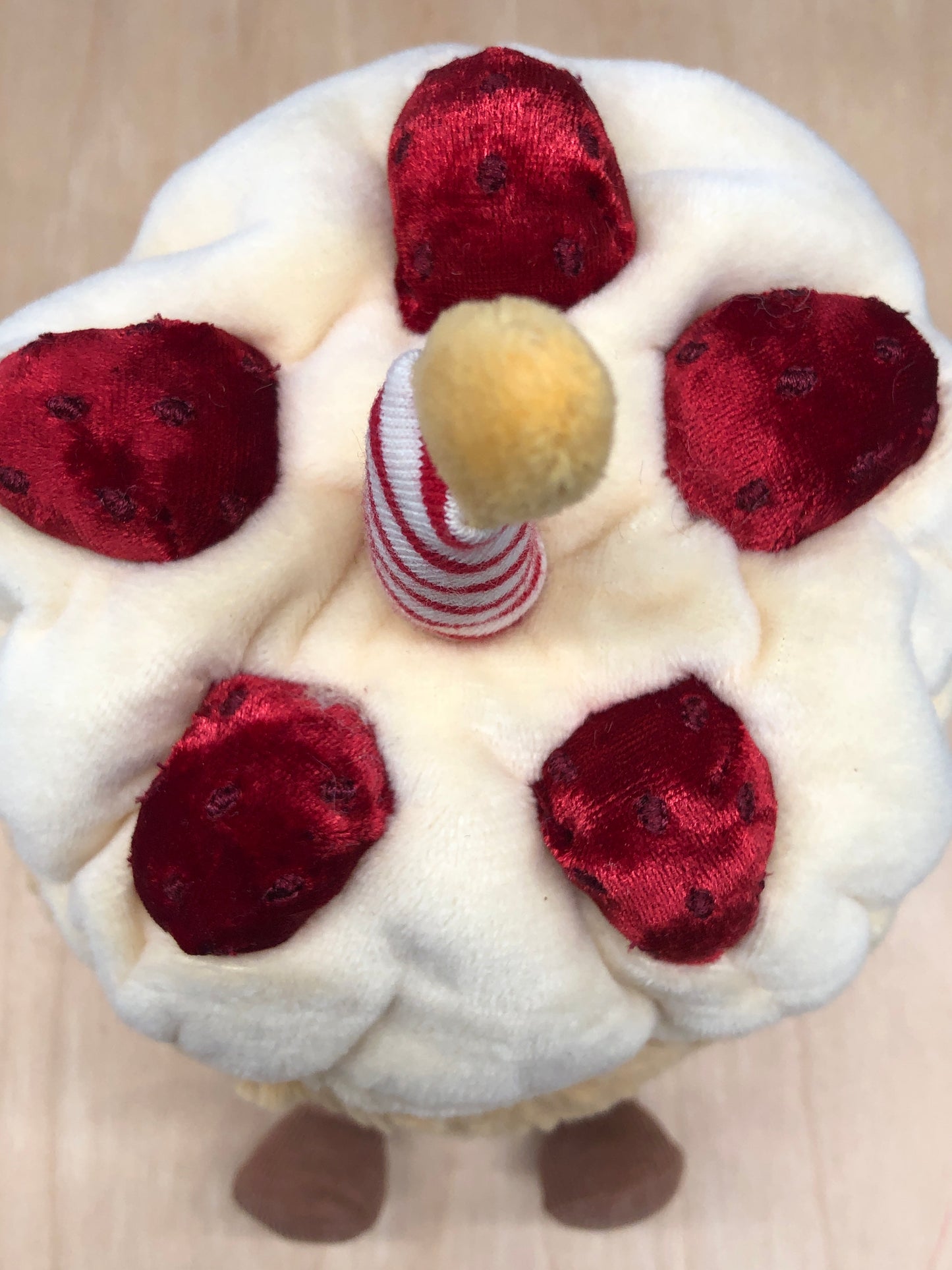 Jellycat Amuseables Birthday Cake plush toy with soft cream frosting, red velvet strawberries, and striped candle on top