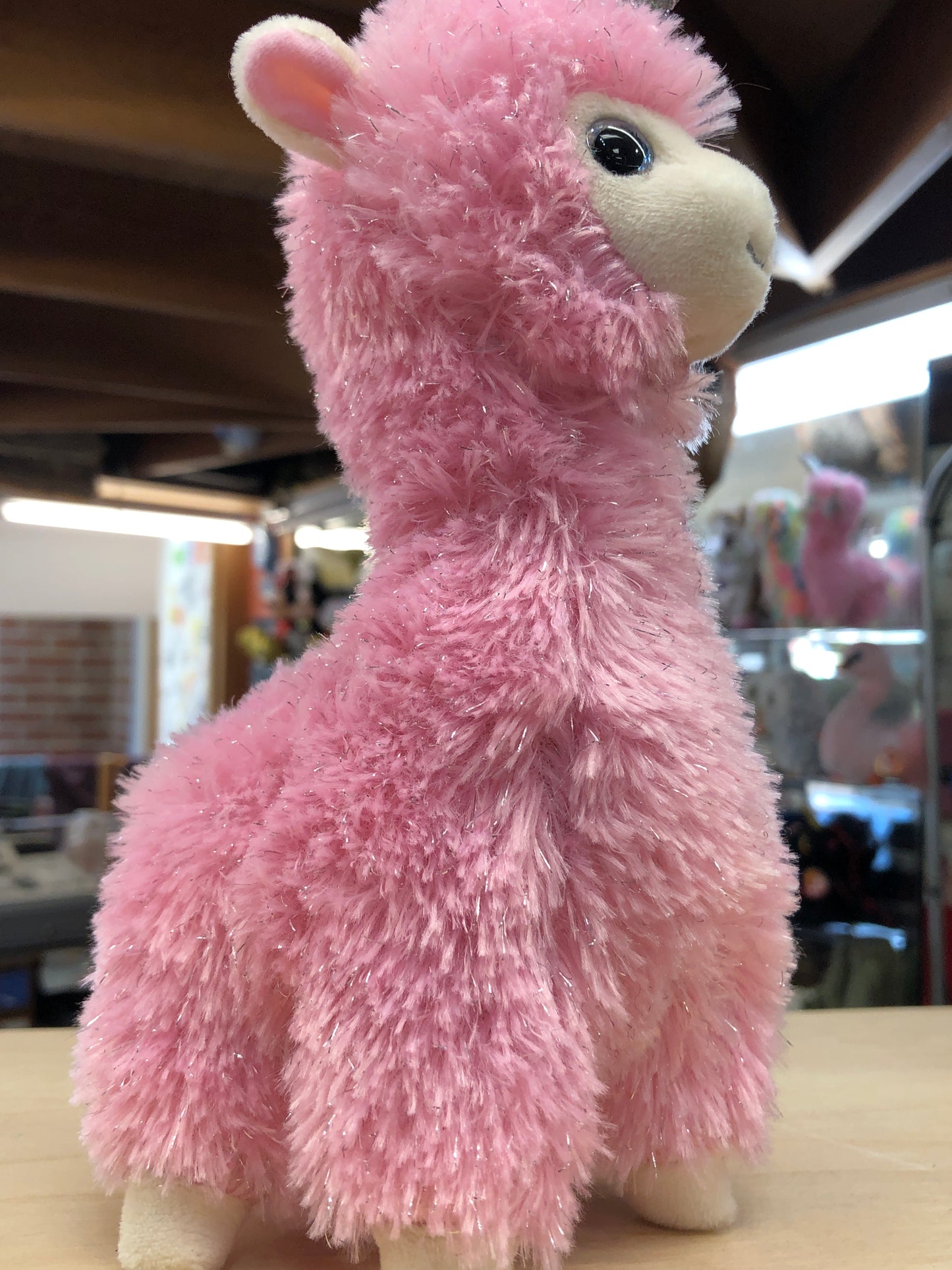 Pink Ty Beanie Baby llamacorn plush toy with soft fur and white face, showcasing magical Lana character for children