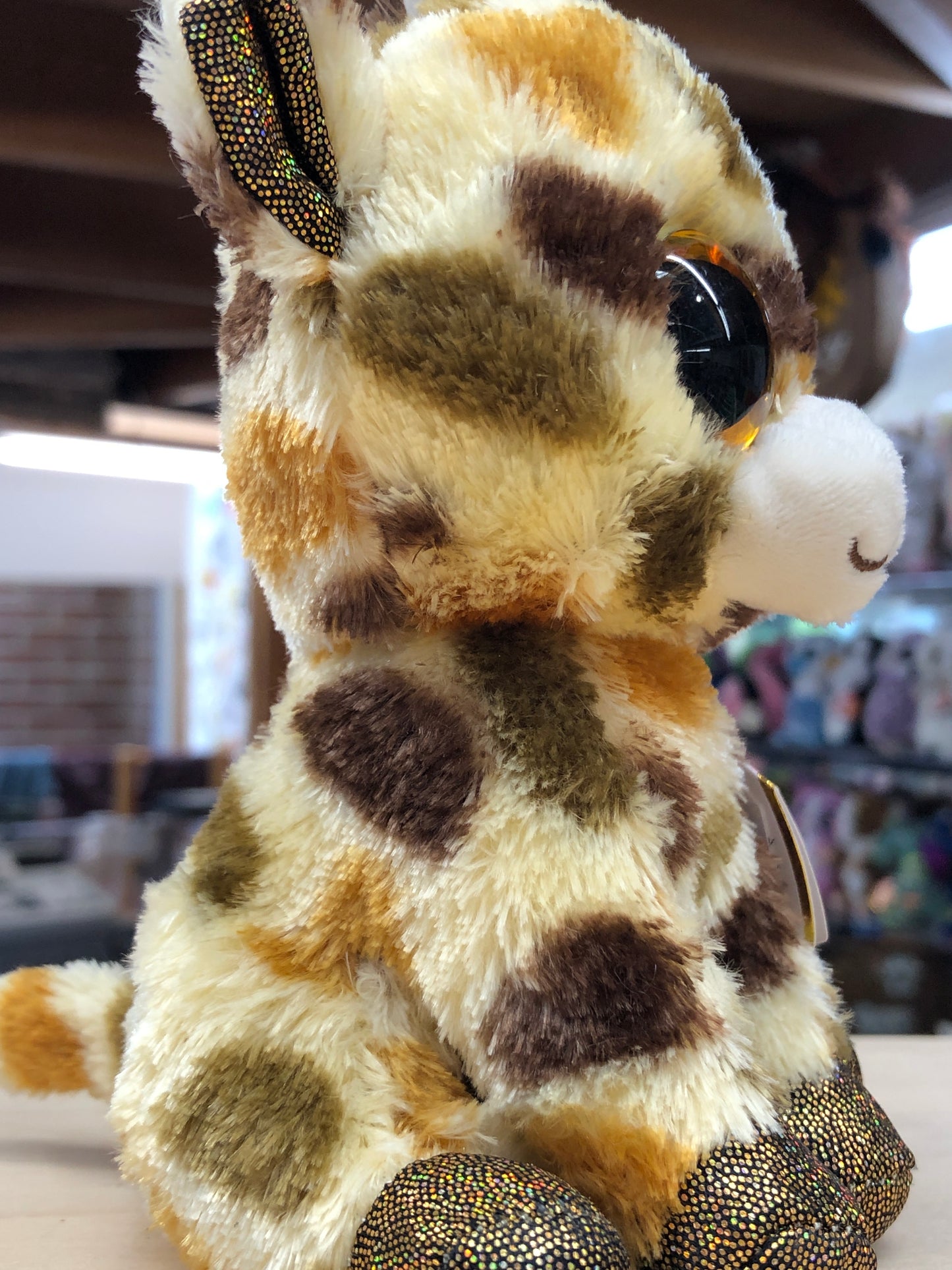 Cute Ty Beanie Boo giraffe plush with spotted pattern, large sparkly eyes, and shimmery hooves, perfect for cuddling