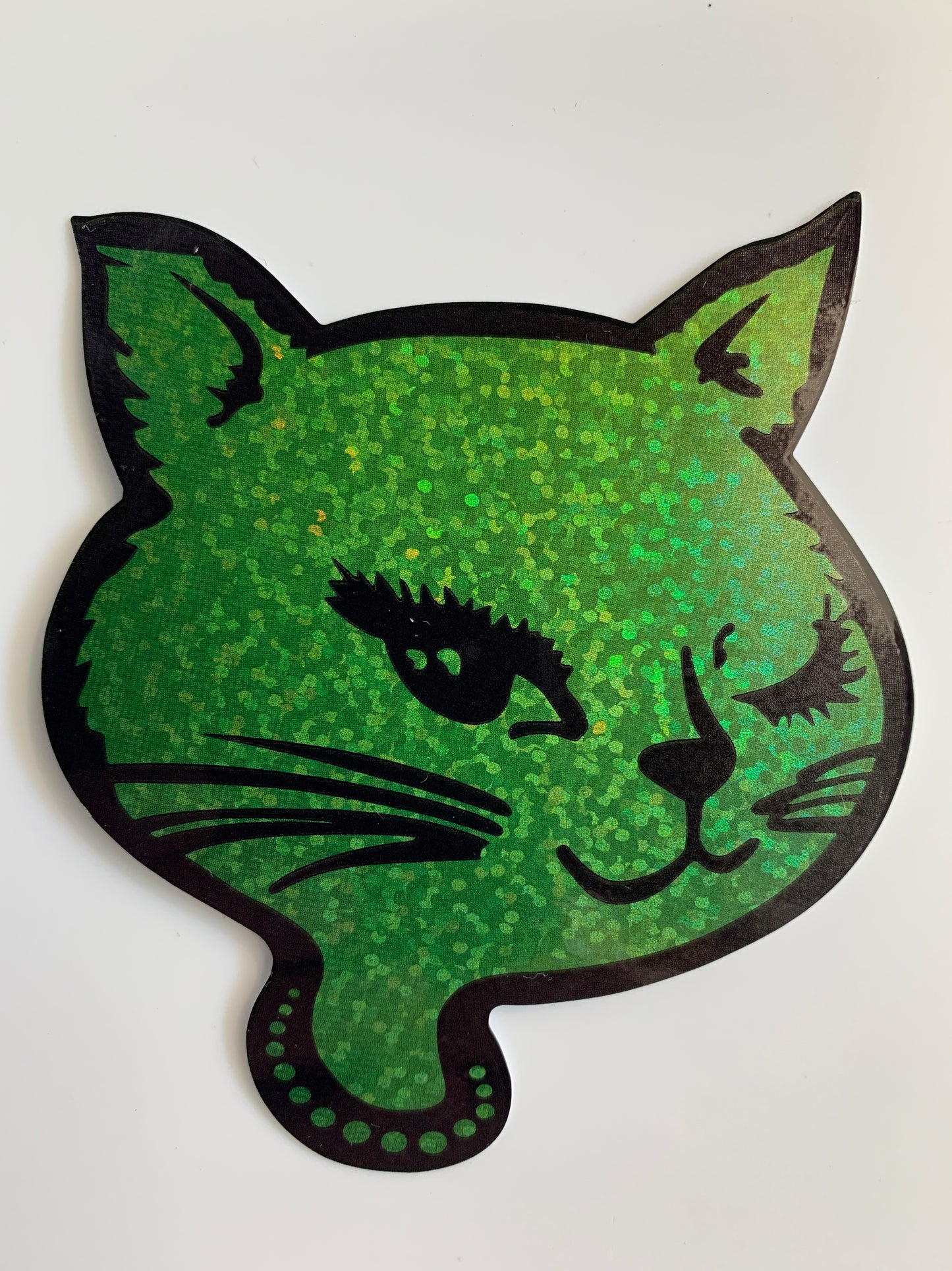 Green glitter winking cat sticker with black outline, showcasing retro 90s design on white background