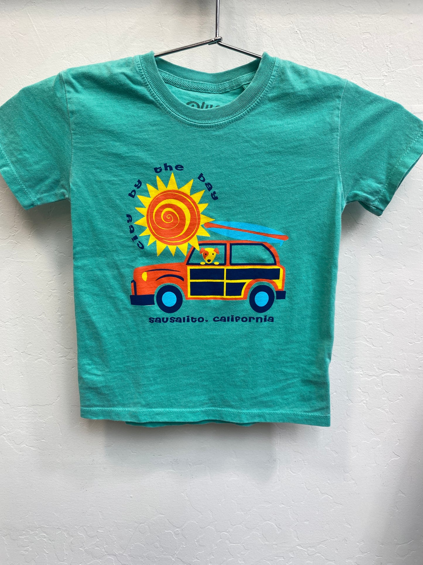 Teal toddler t-shirt with colorful beach design featuring sun and surf wagon, Sausalito California souvenir