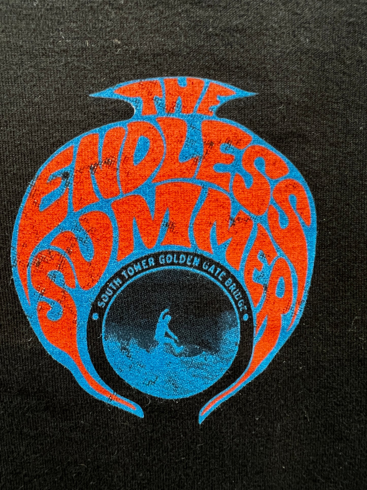 Retro Sausalito Endless Summer t-shirt logo with surfer and Golden Gate Bridge, orange and blue on black fabric