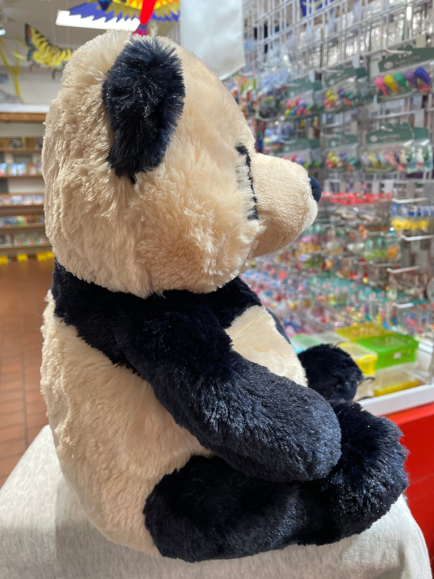 Gund Zi-Bo panda plush toy with unique navy and cream color pattern, sitting in a toy store display