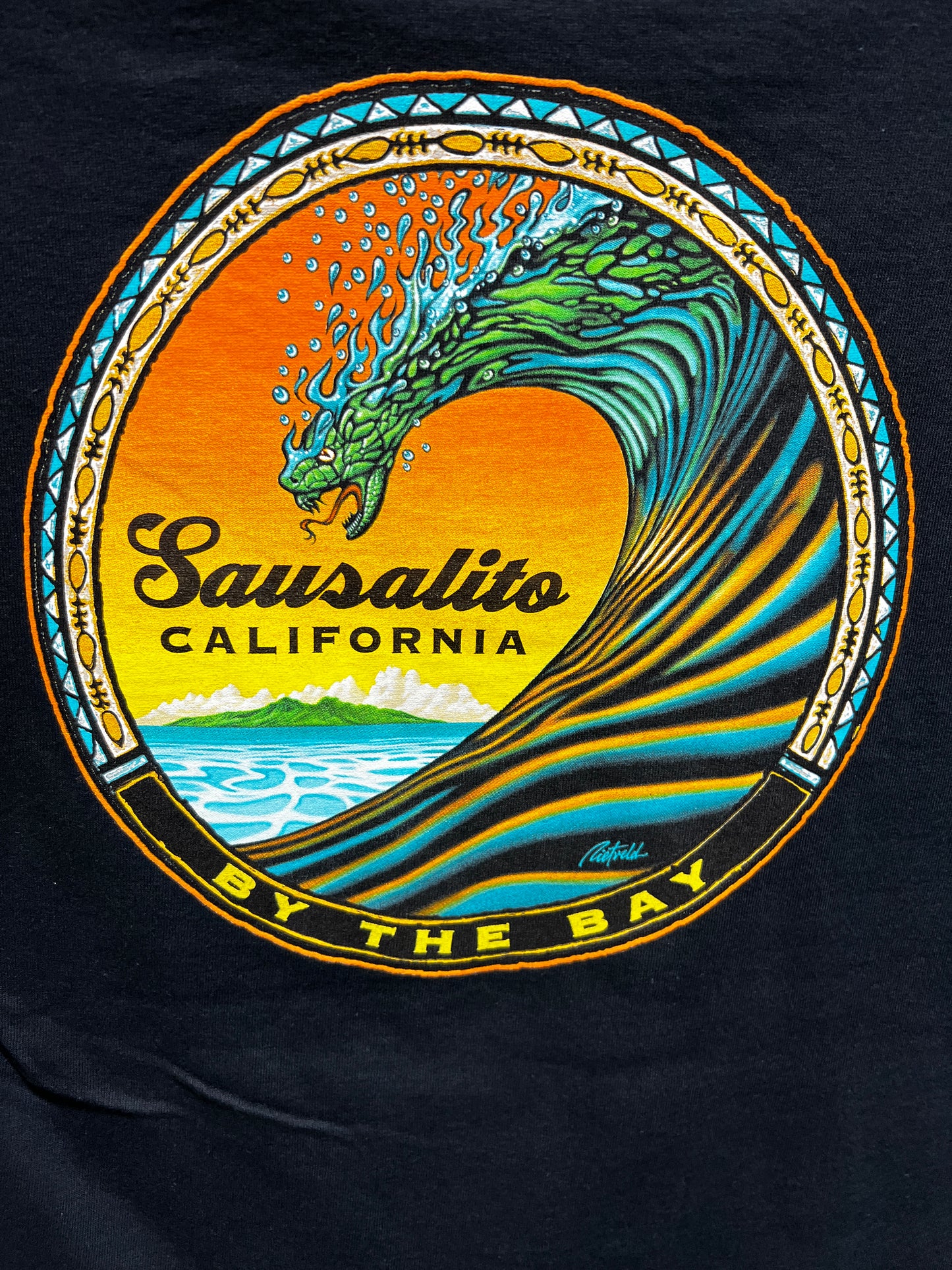 Sausalito Snake Wave t-shirt design featuring colorful ocean wave shaped like a serpent against sunset backdrop and mountains