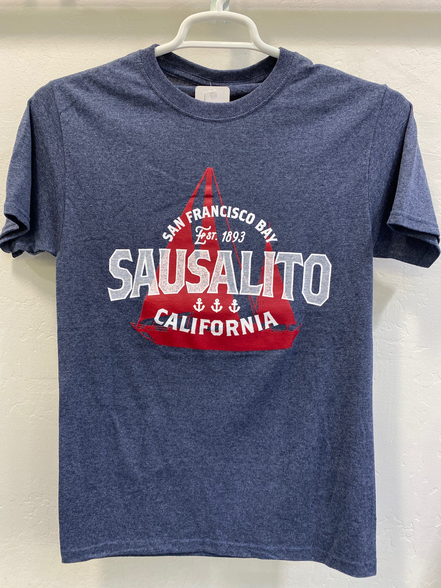 Navy blue t-shirt with Sausalito San Francisco Bay sailboat design, featuring red and white text and nautical elements