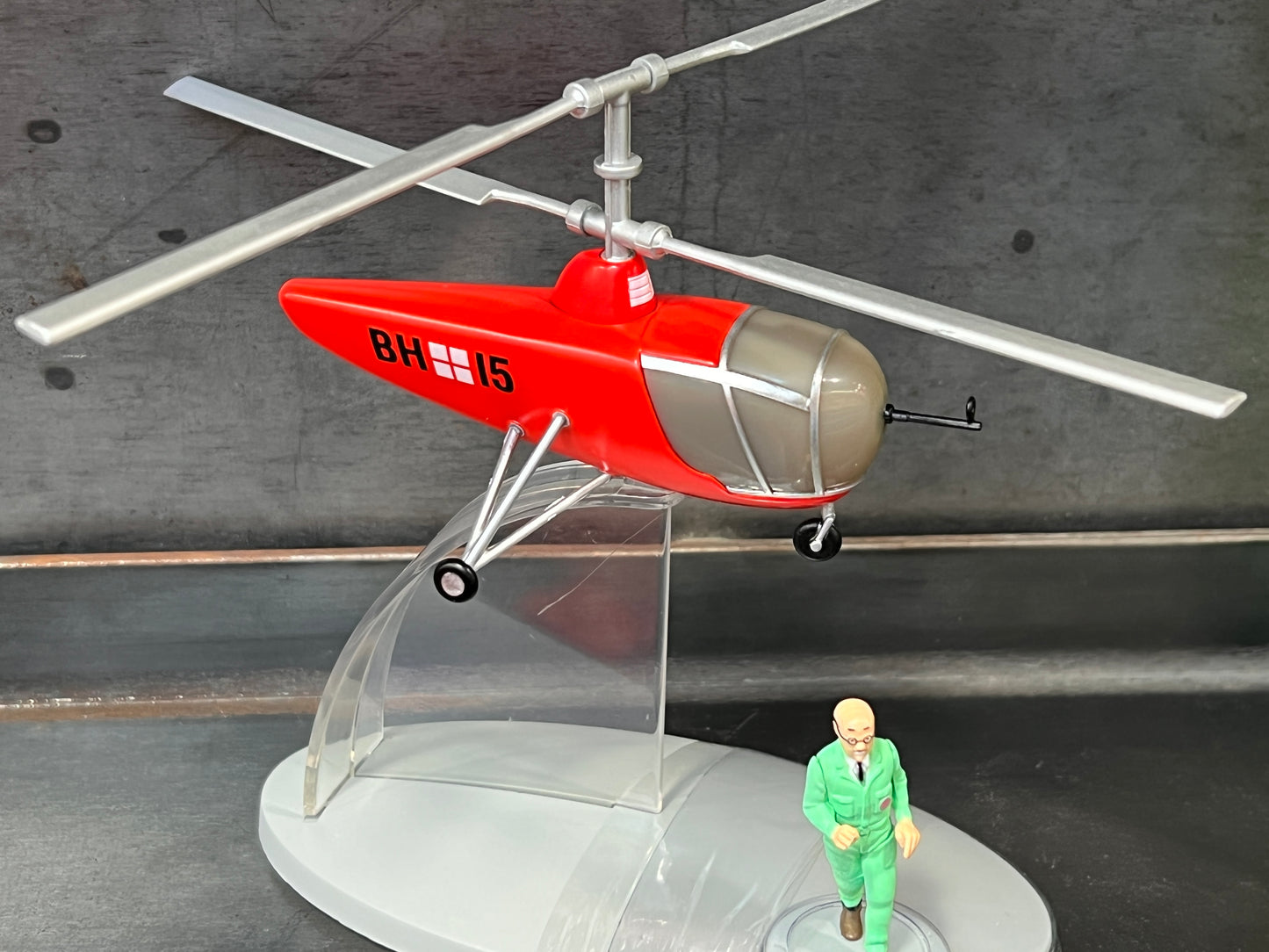 Model of Hiller UH-4 helicopter from "Destination Moon" with BH15 marking, displayed on stand with small figure in green suit