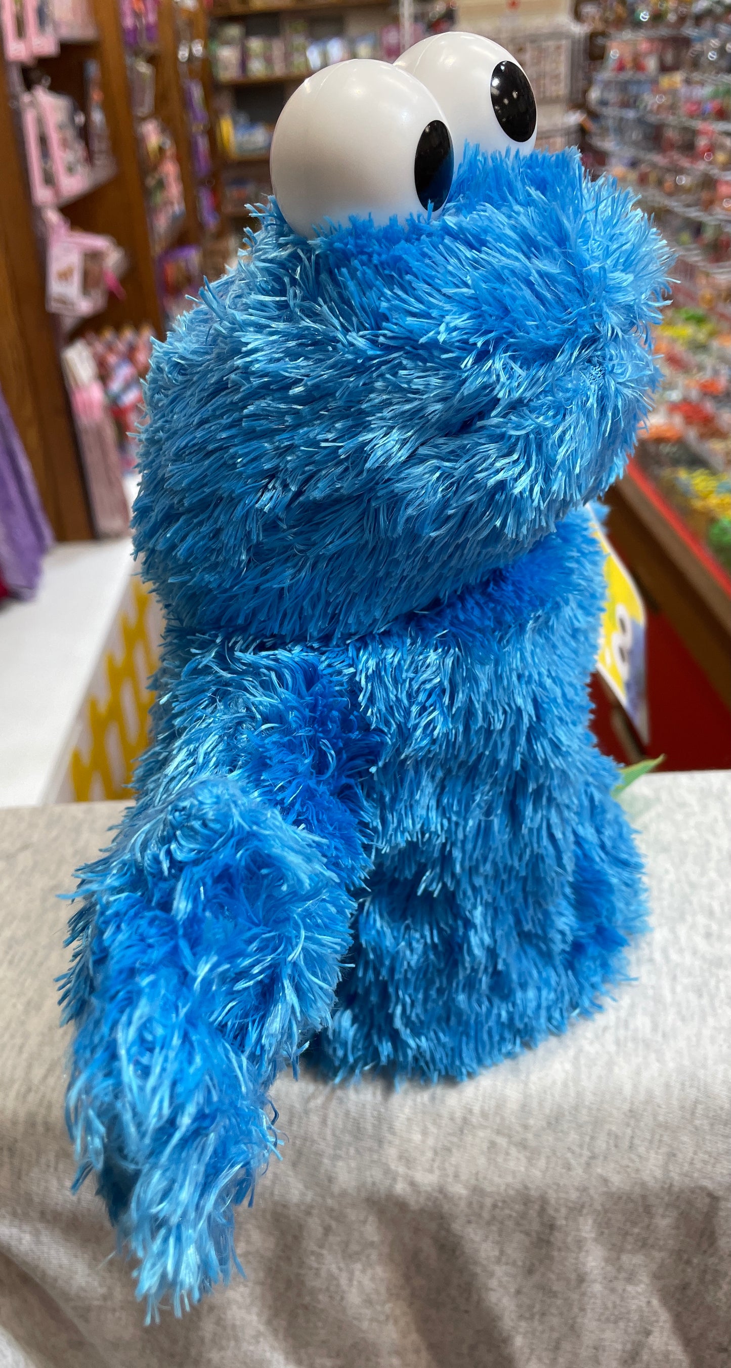 Gund Cookie Monster hand puppet, plush blue character with large eyes, perfect for imaginative play and Sesame Street fans