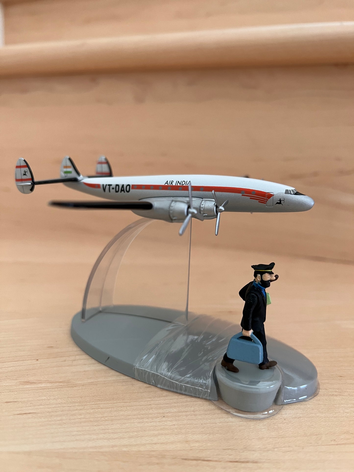 Air India Lockheed Constellation model from Tintin in Tibet, with character figurine on display stand