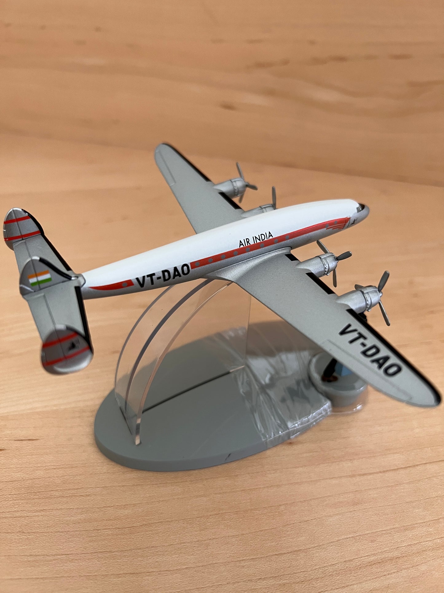 Model Air India Lockheed Constellation airplane from Tintin in Tibet, displaying VT-DAO registration on stand