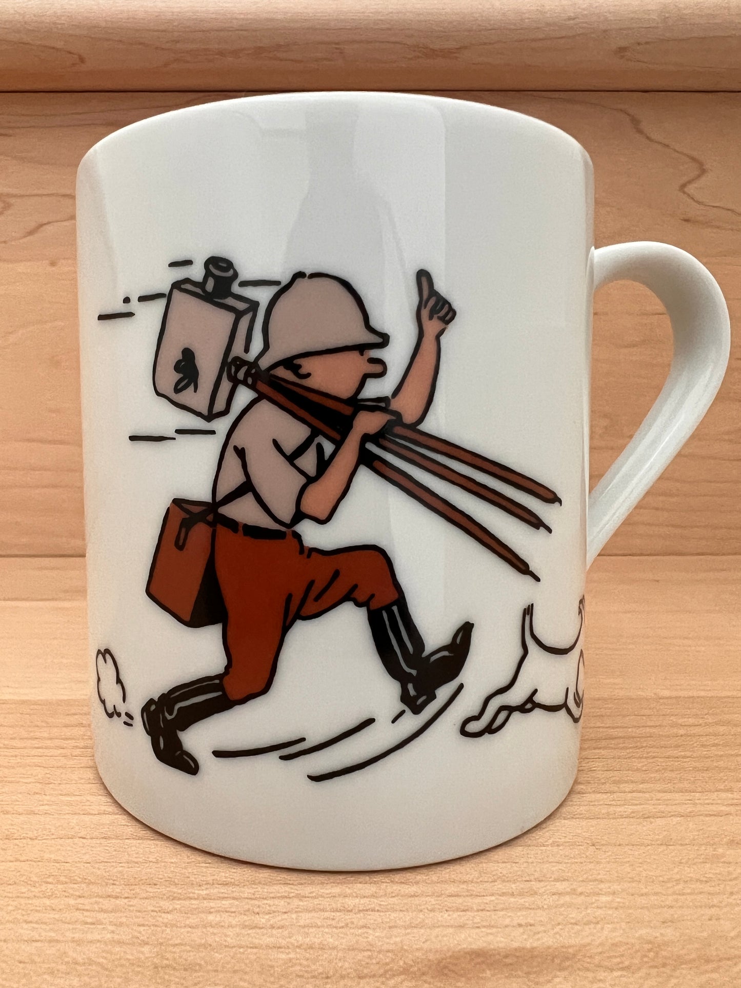 Tintin mug featuring cartoon reporter running with crank camera, dog at feet, in colorized and black-and-white designs