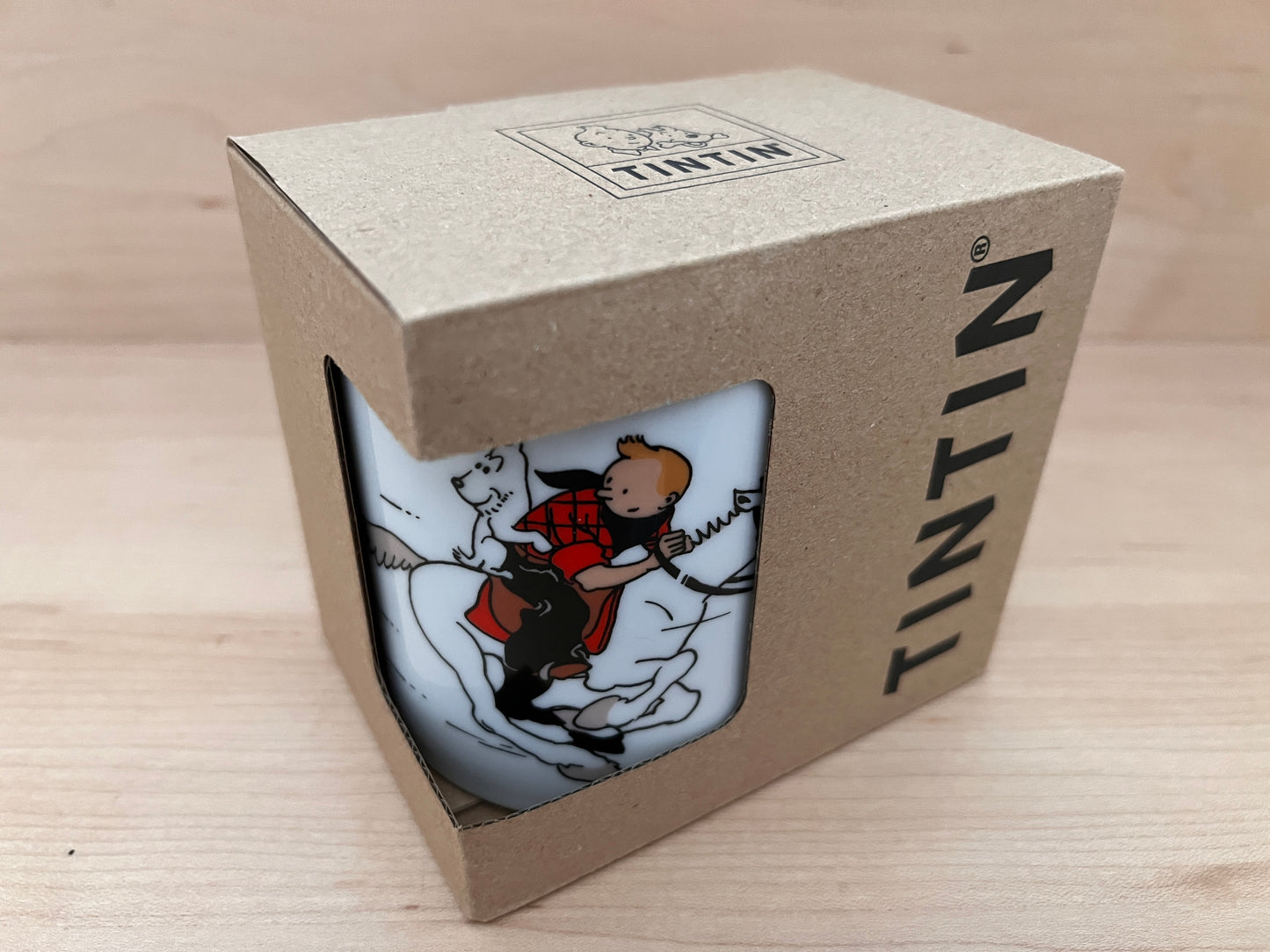 Tintin in America mug in gift box, showing cartoon character riding horse with dog, packaged in cardboard Tintin-branded container
