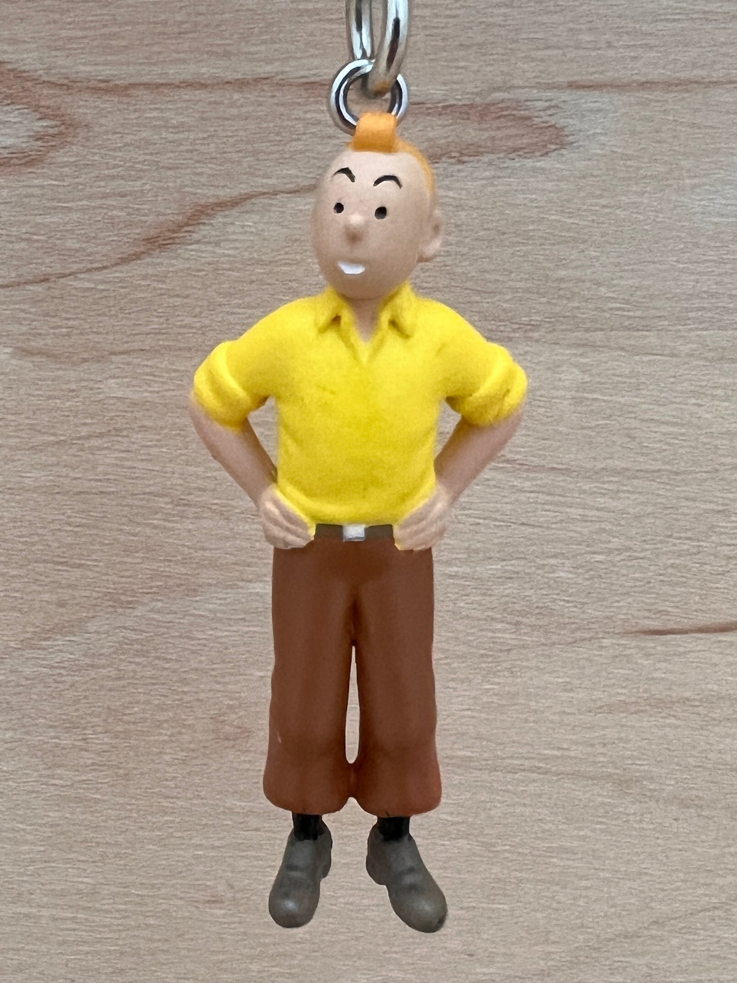 Tintin keychain figure with hands on hips, yellow shirt, brown pants, 5.5cm tall PVC mini collectible