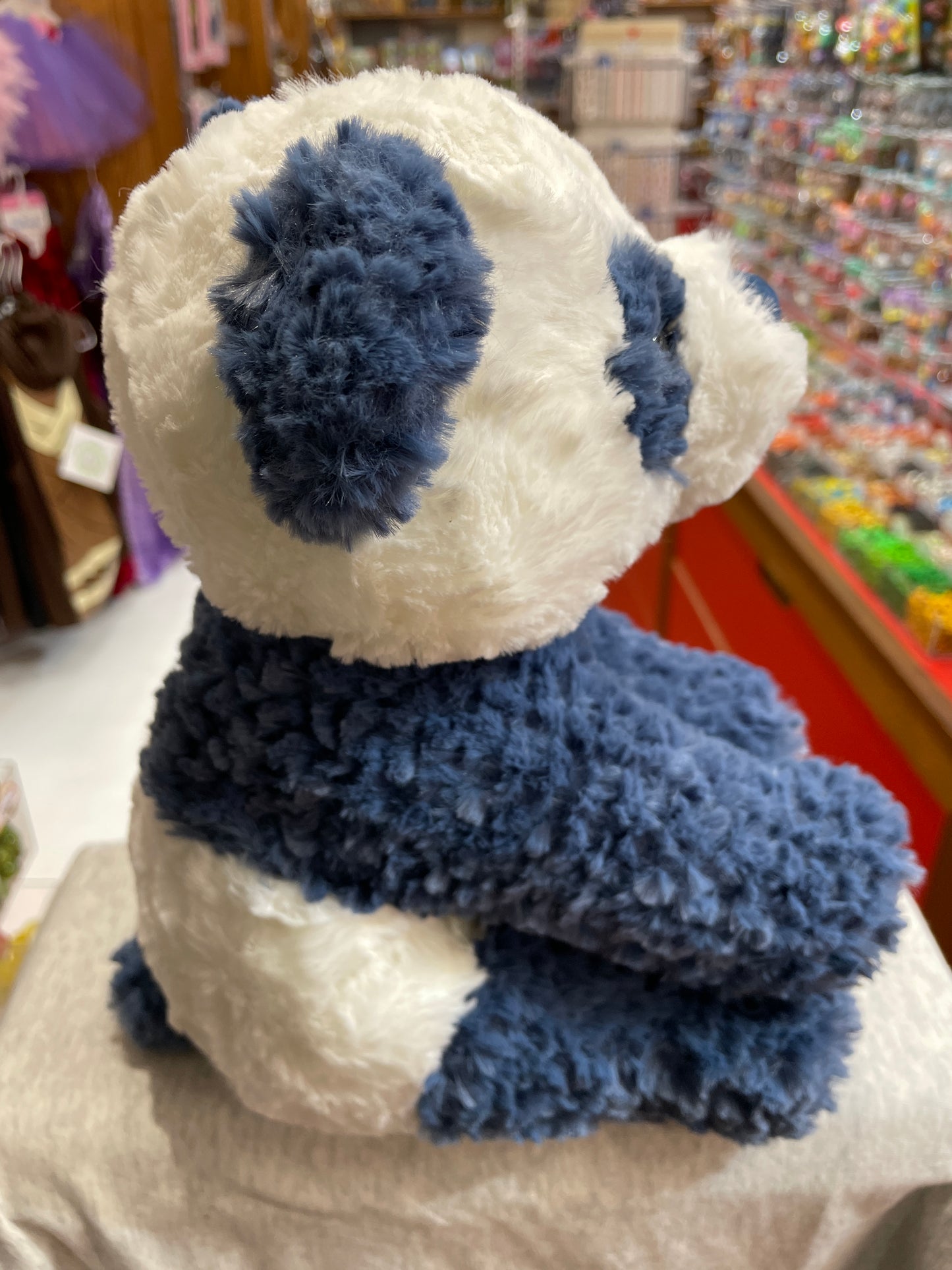 Soft, cuddly Gund Cozys panda plush toy with white and navy fur, floppy limbs, and textured fabric, perfect for hugging