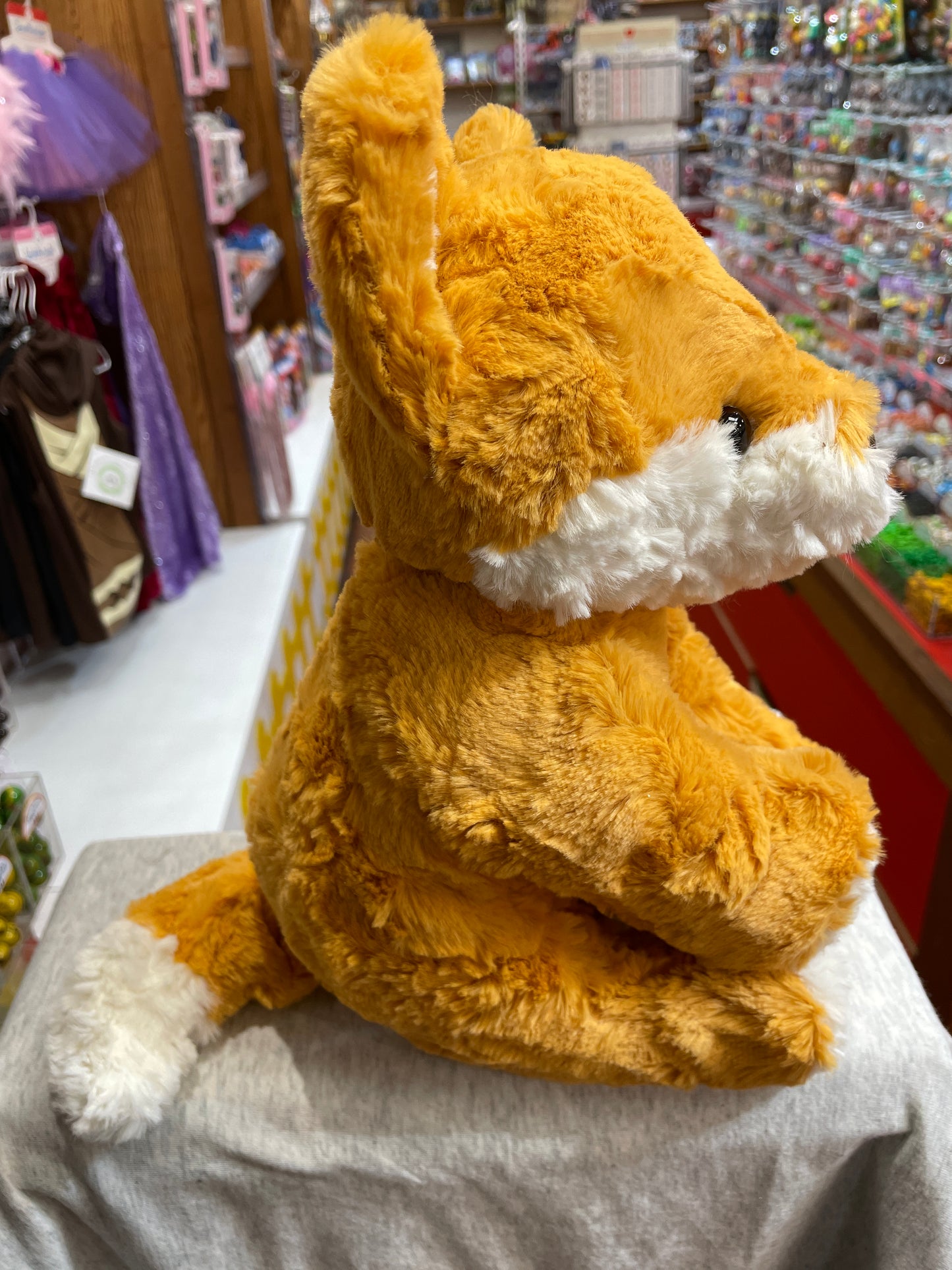 Gund Cozys fox plush toy with soft orange and white fur, sitting in toy store display, perfect for cuddling