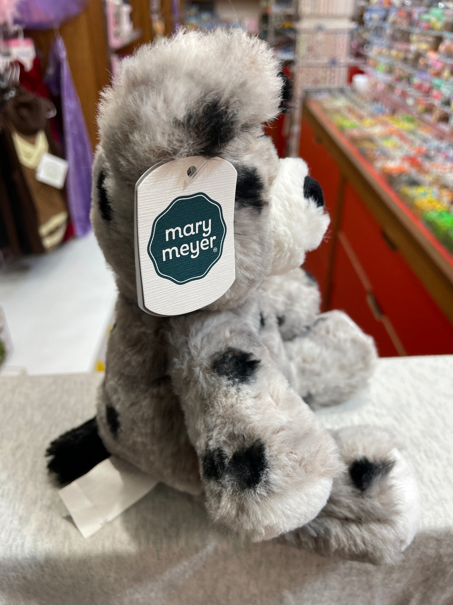 Soft, spotted Mary Meyer plush puppy toy from Marshmallow Zoo collection, displayed in store with brand tag