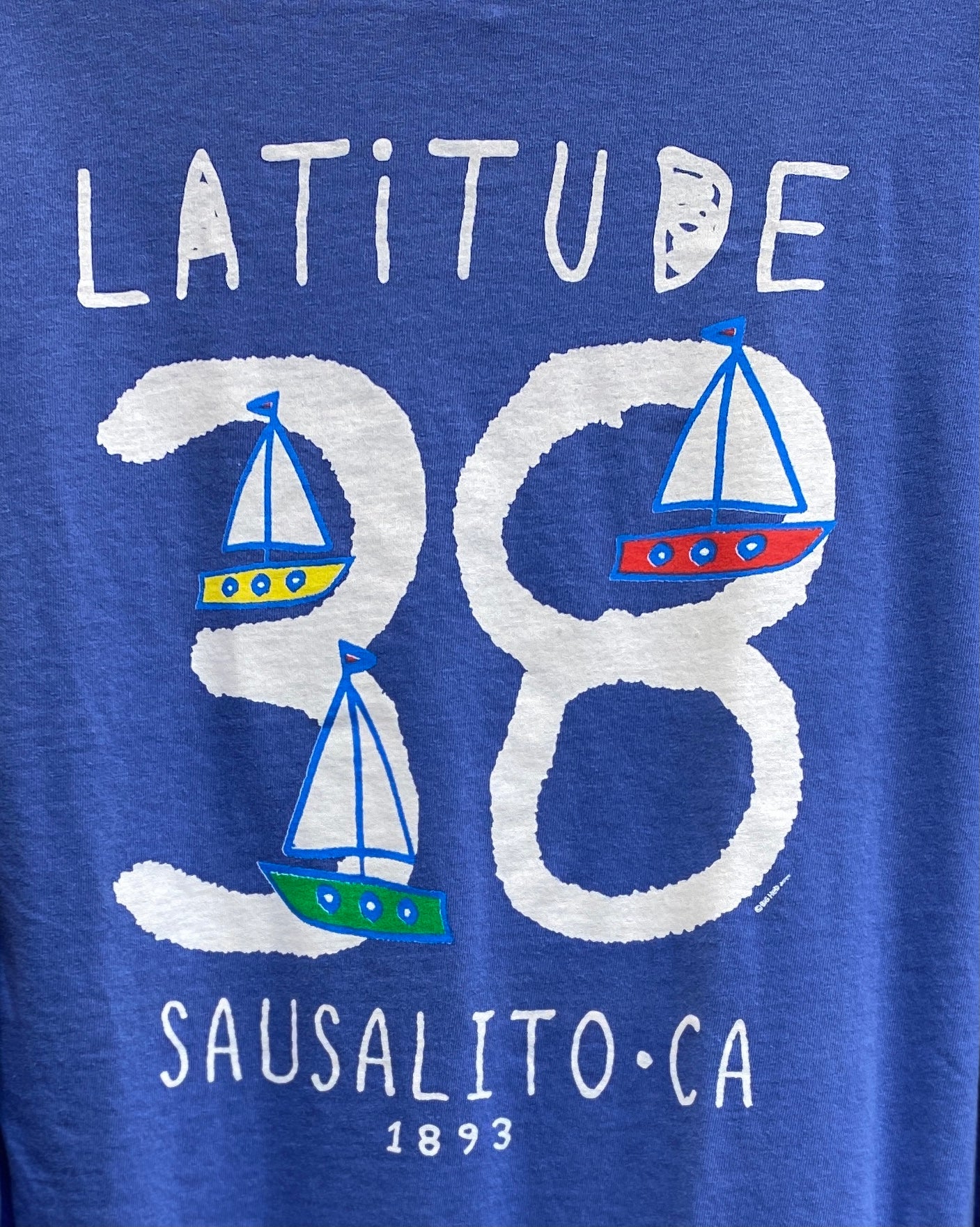 Sausalito Latitude 38 t-shirt design with colorful sailboats forming the number 38, showcasing the town's nautical heritage