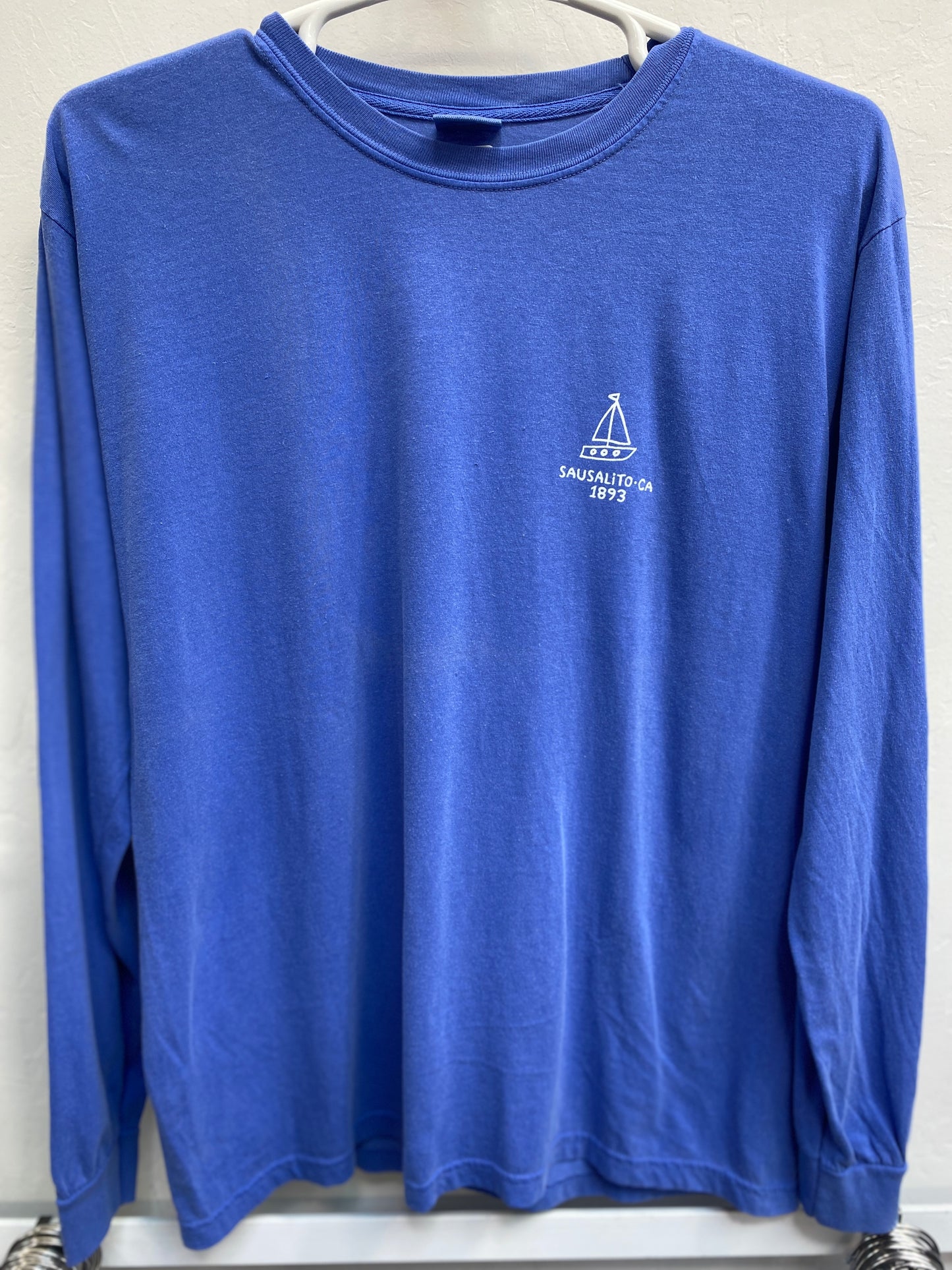 Blue long sleeve unisex t-shirt with Sausalito sailboat logo, commemorating town's 1893 establishment on San Francisco Bay