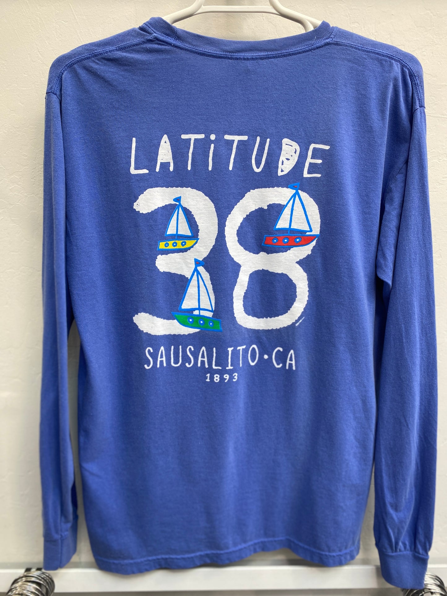 Blue long sleeve t-shirt with Sausalito Latitude 38 design featuring sailboats and established date 1893