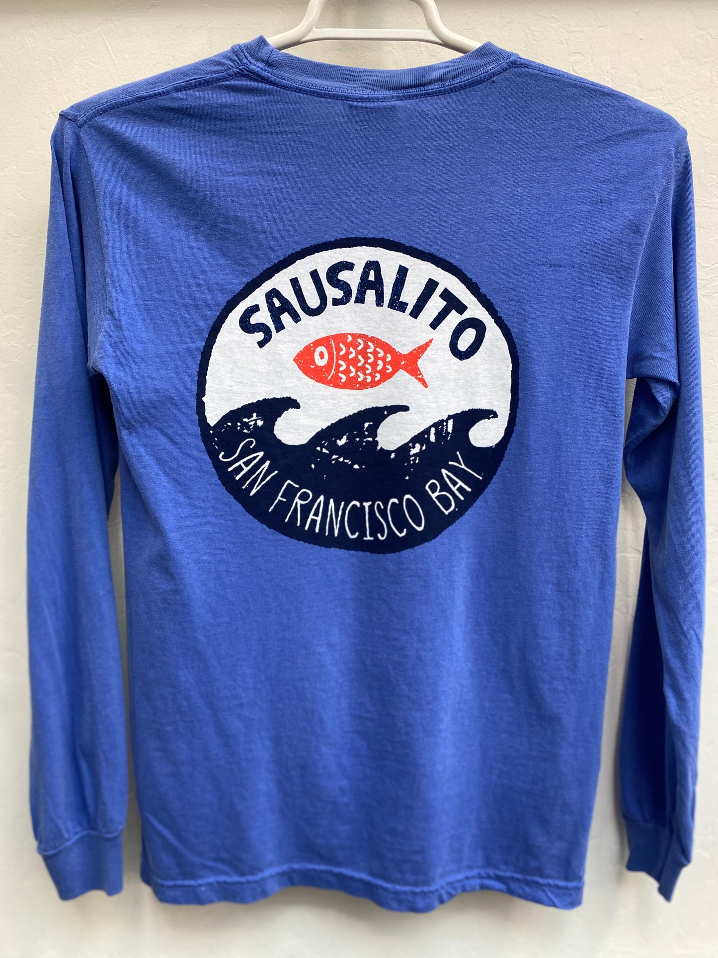 Blue long sleeve shirt with Sausalito San Francisco Bay logo featuring fish jumping over waves