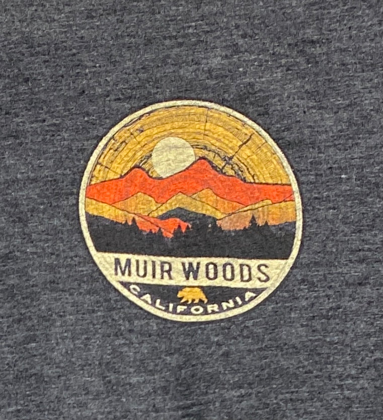 Muir Woods t-shirt design featuring sunset over mountains and redwoods, circular logo on charcoal fabric