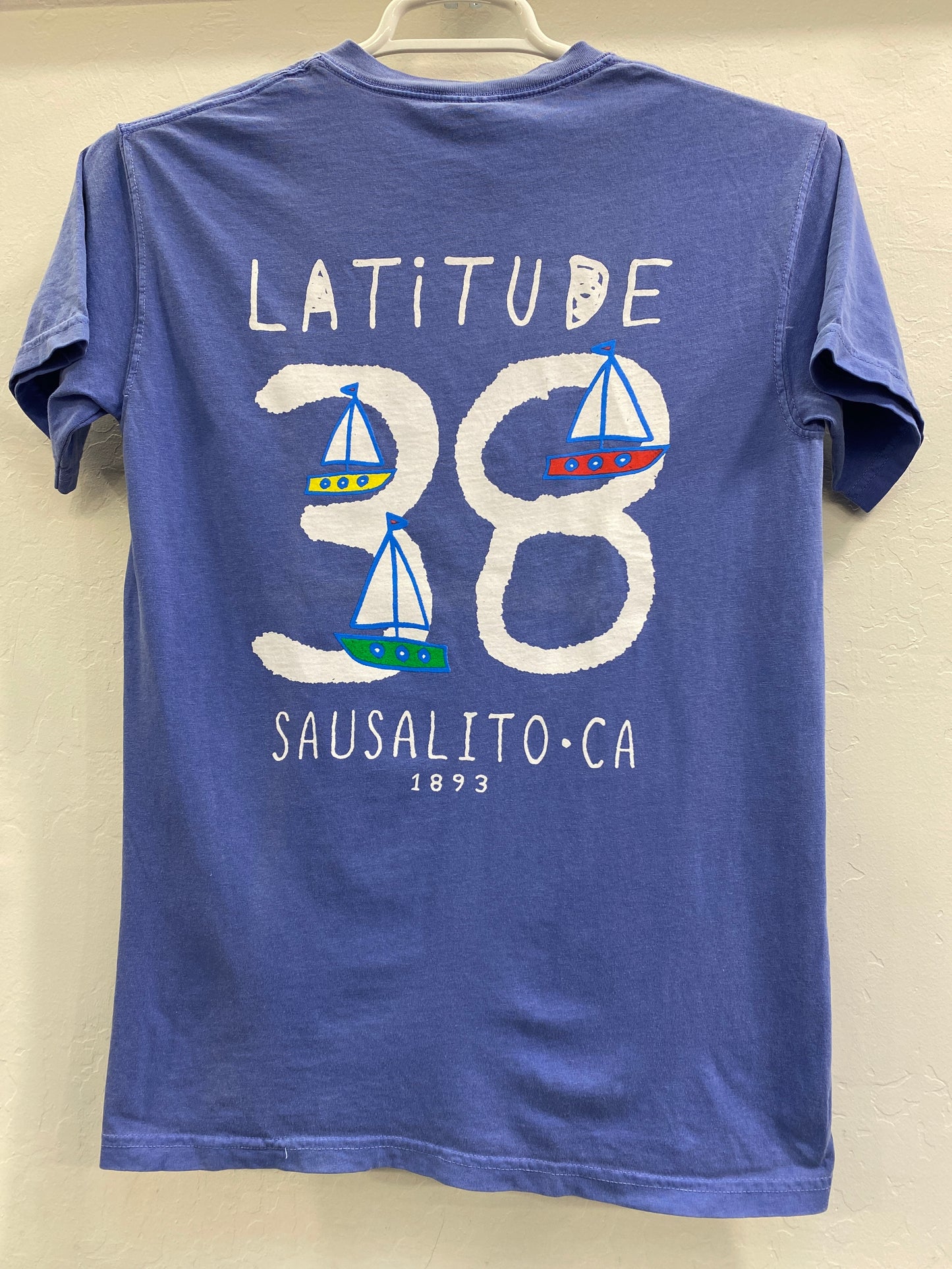 Blue t-shirt with "Latitude 38 Sausalito, CA 1893" design featuring sailboat illustrations, showcasing Sausalito's maritime heritage