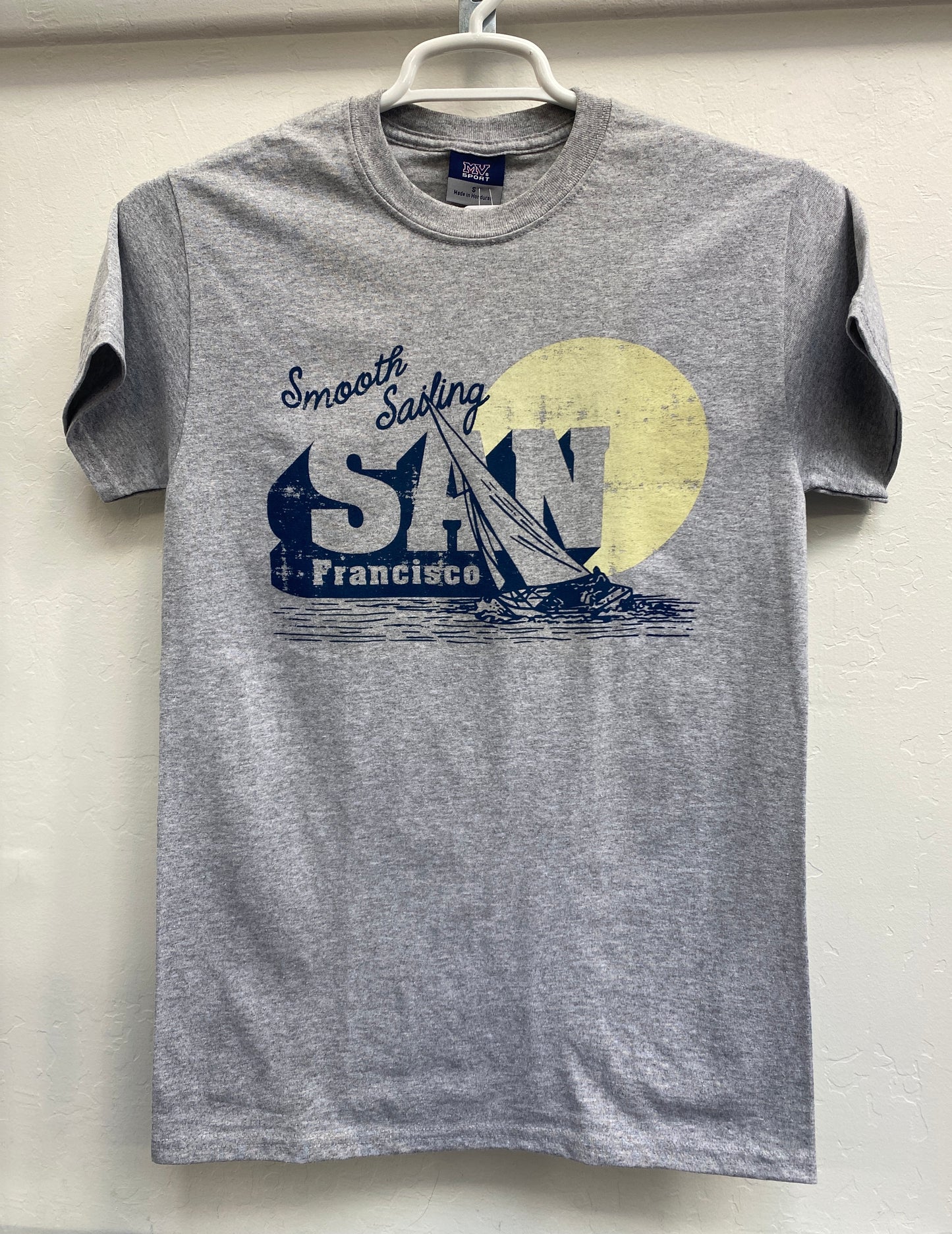 Gray t-shirt with "Smooth Sailing San Francisco" design featuring sailboat and yellow sun, unisex short sleeve style