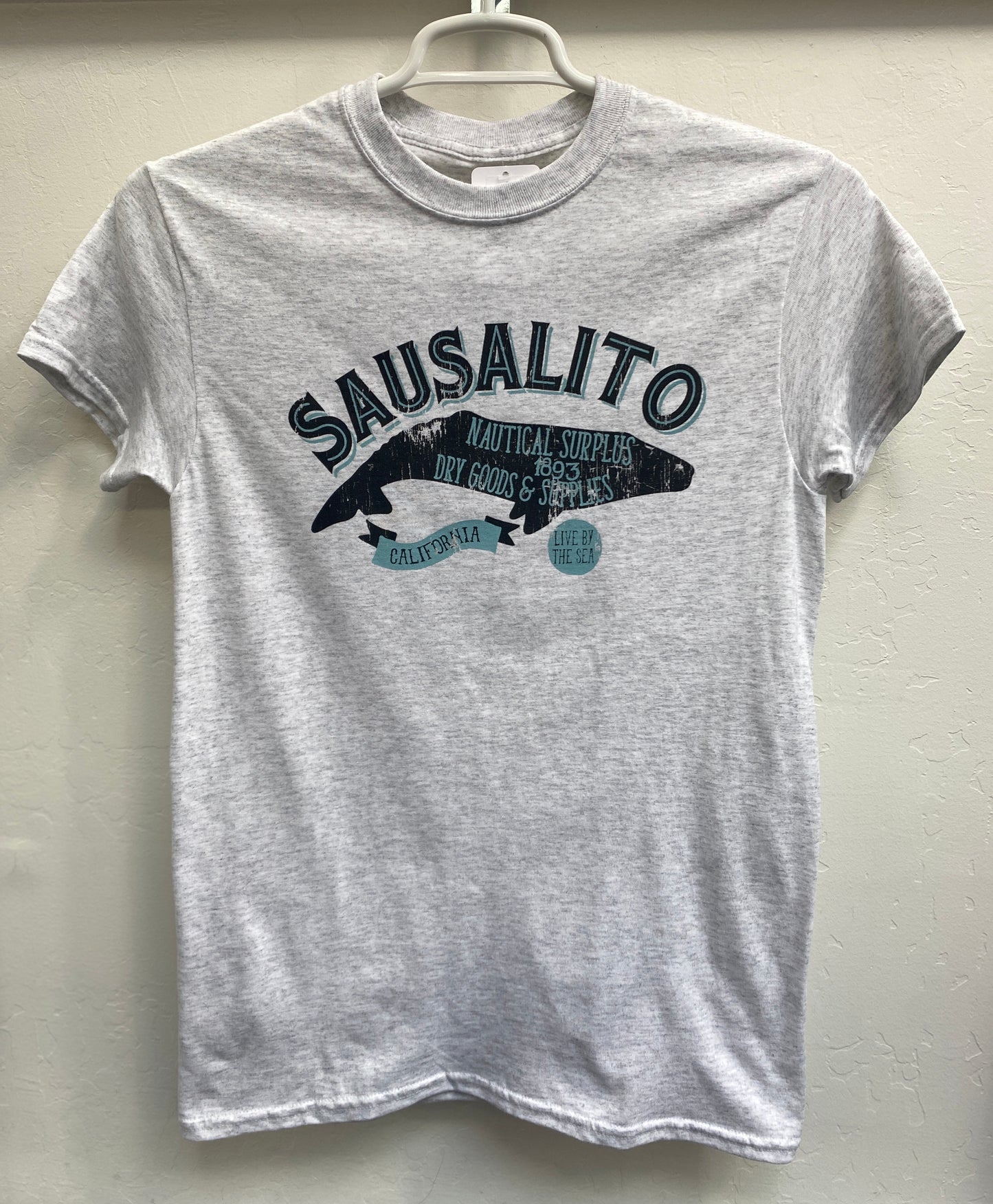 Sausalito Dry Goods unisex t-shirt with nautical design featuring whale-shaped logo and text "California" and "Live by the Sea"