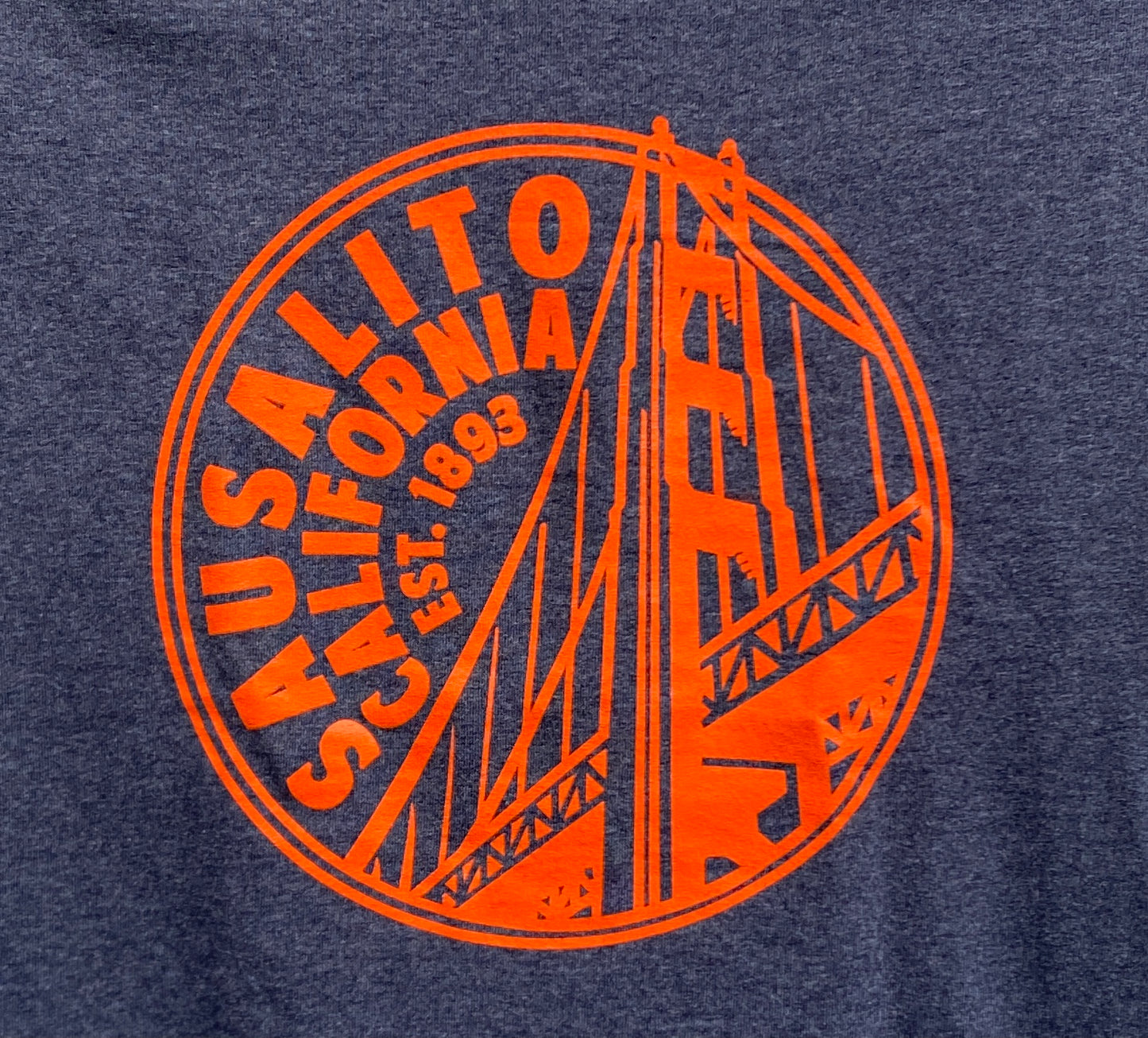 Sausalito Golden Gate Bridge coin design on navy t-shirt, orange graphic showing bridge tower and "Est. 1893"