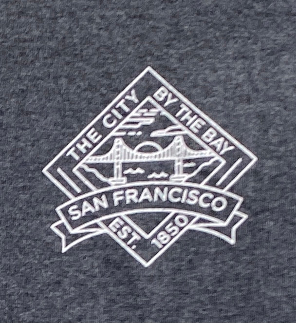 San Francisco t-shirt logo with Golden Gate Bridge outline and "The City by the Bay" text on gray fabric